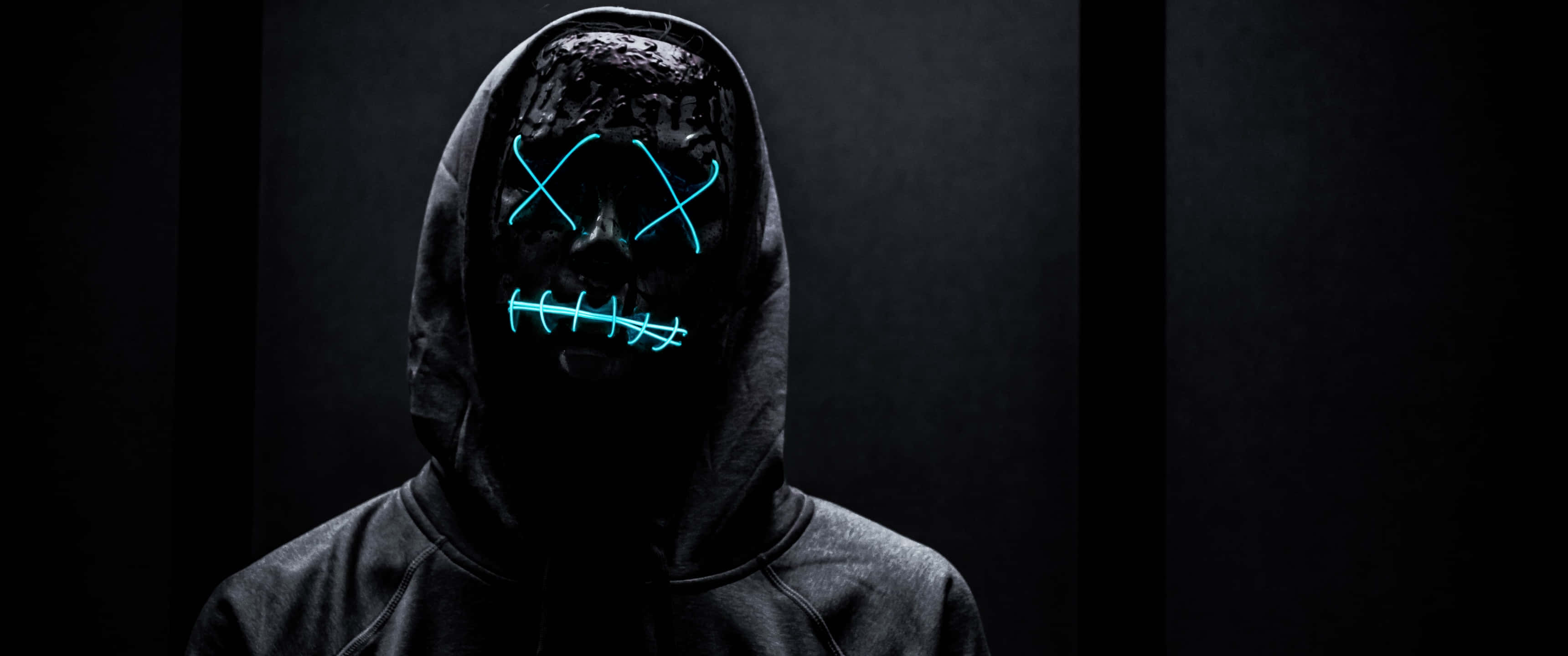 glowing blue stitched mask, hooded figure, neon light, 2K Desktop Wallpaper