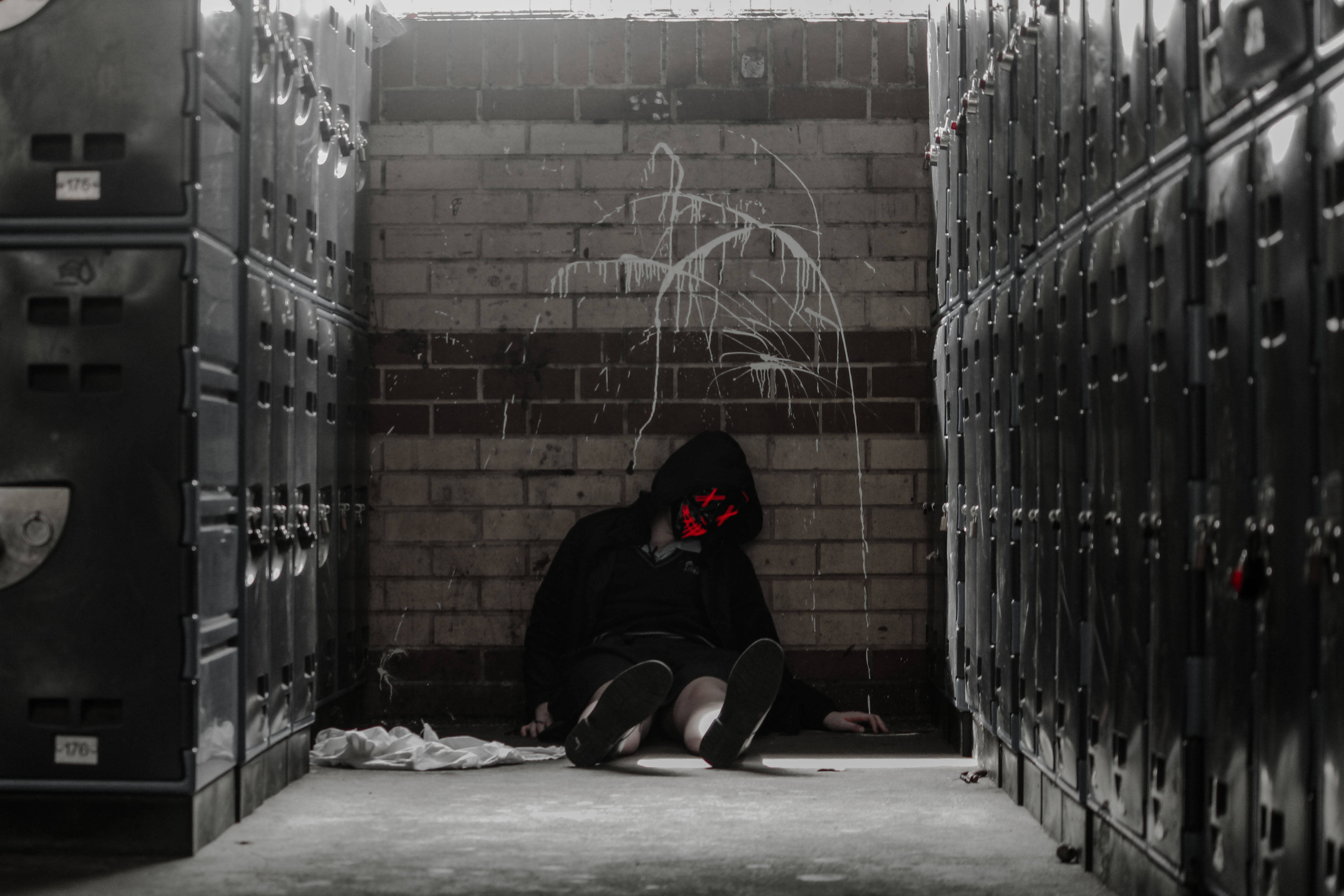 hooded figure, glowing red eyes, metal lockers, 4K Desktop Wallpaper