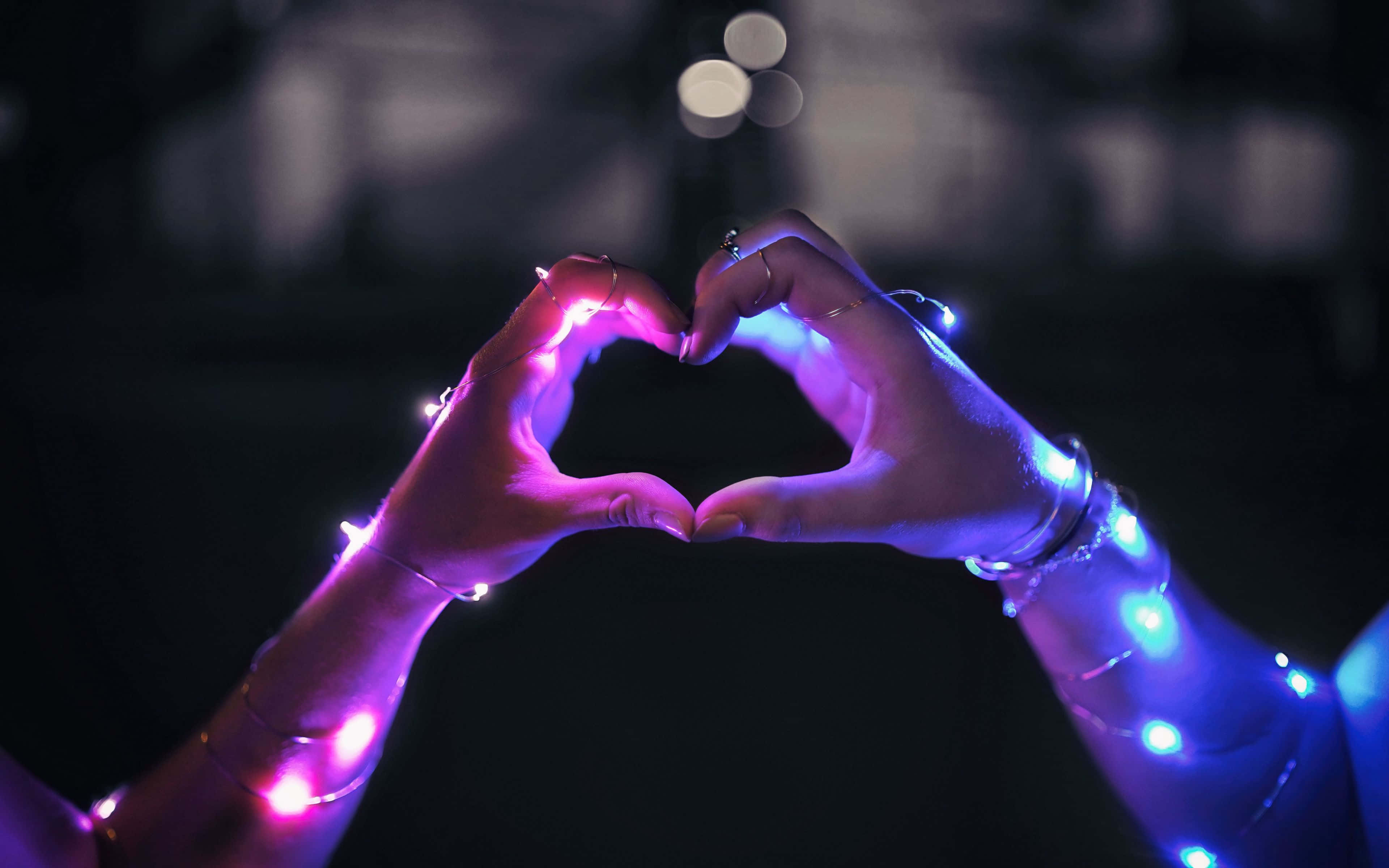 Mutual Love Lights, glowing heart shape, dark background, 4K Desktop Wallpaper