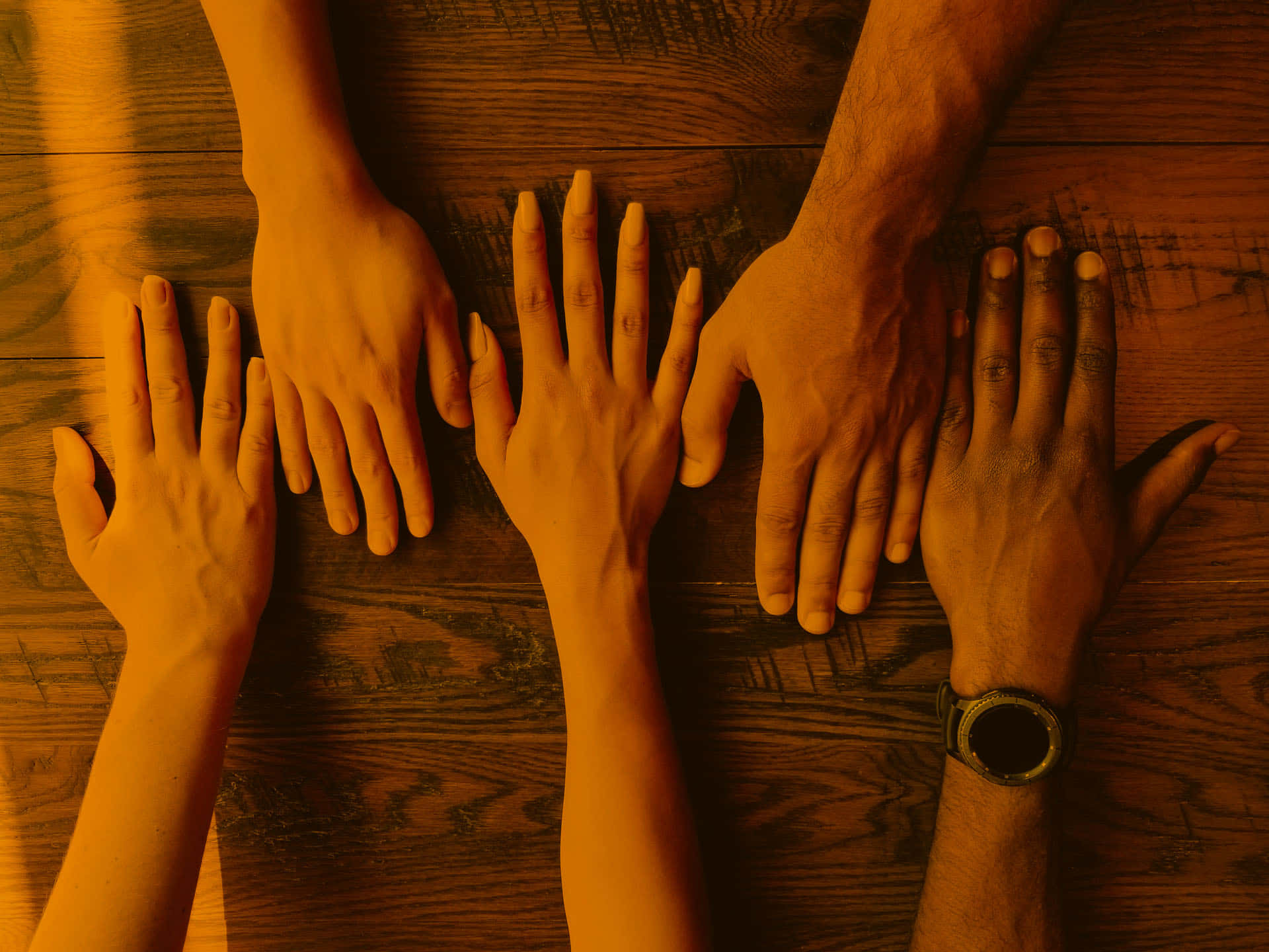 golden lighting, warm wooden table, five diverse hands, Full HD Desktop Wallpaper