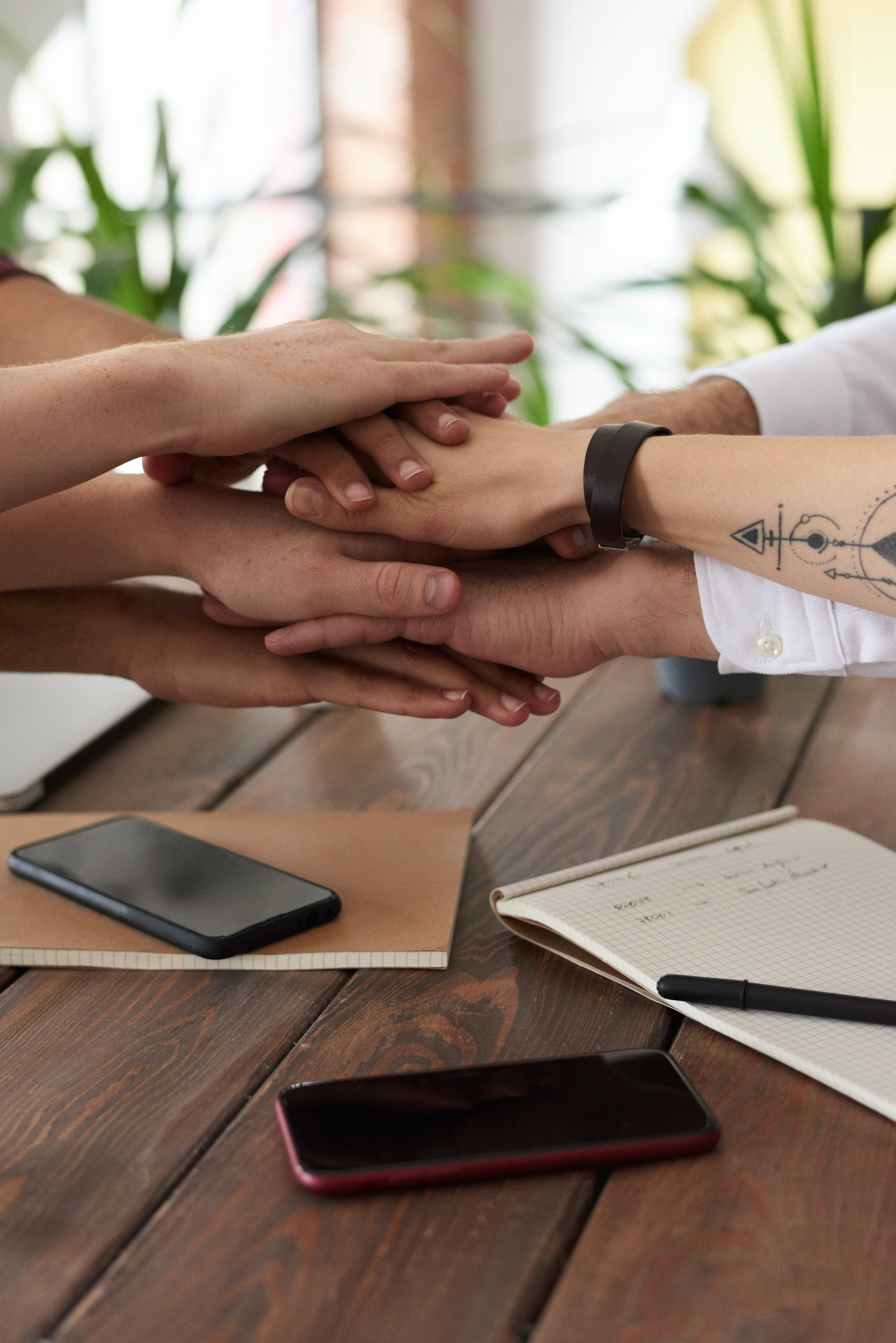 Office Team Hands, diverse people, wooden table, 5K Phone Wallpaper