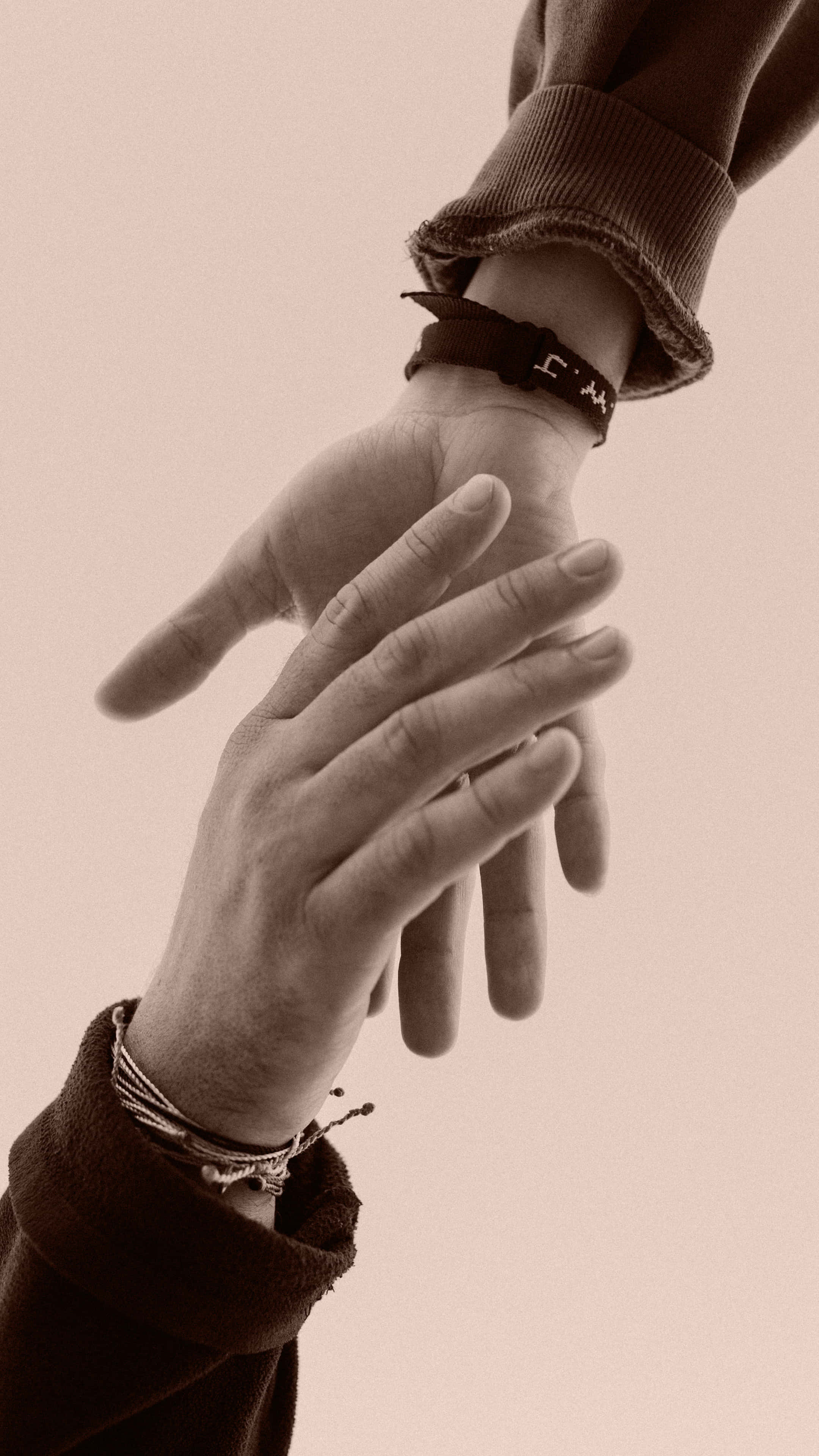 Gentle Handshake With Bracelets, sepia tones, detailed textures, 4K Phone Wallpaper