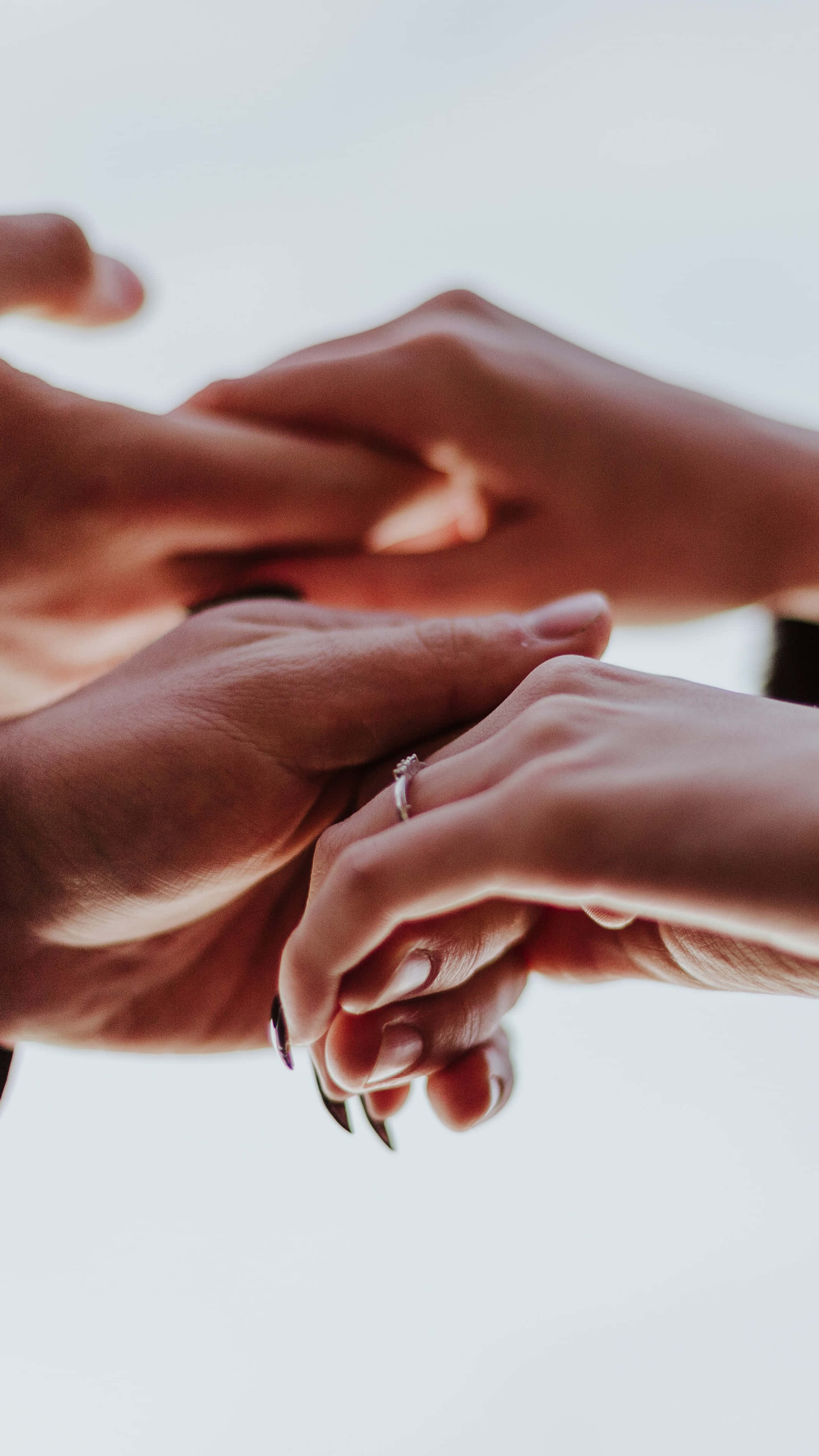 Intimate Handshake, soft blurred background, delicate ring, 4K Phone Wallpaper