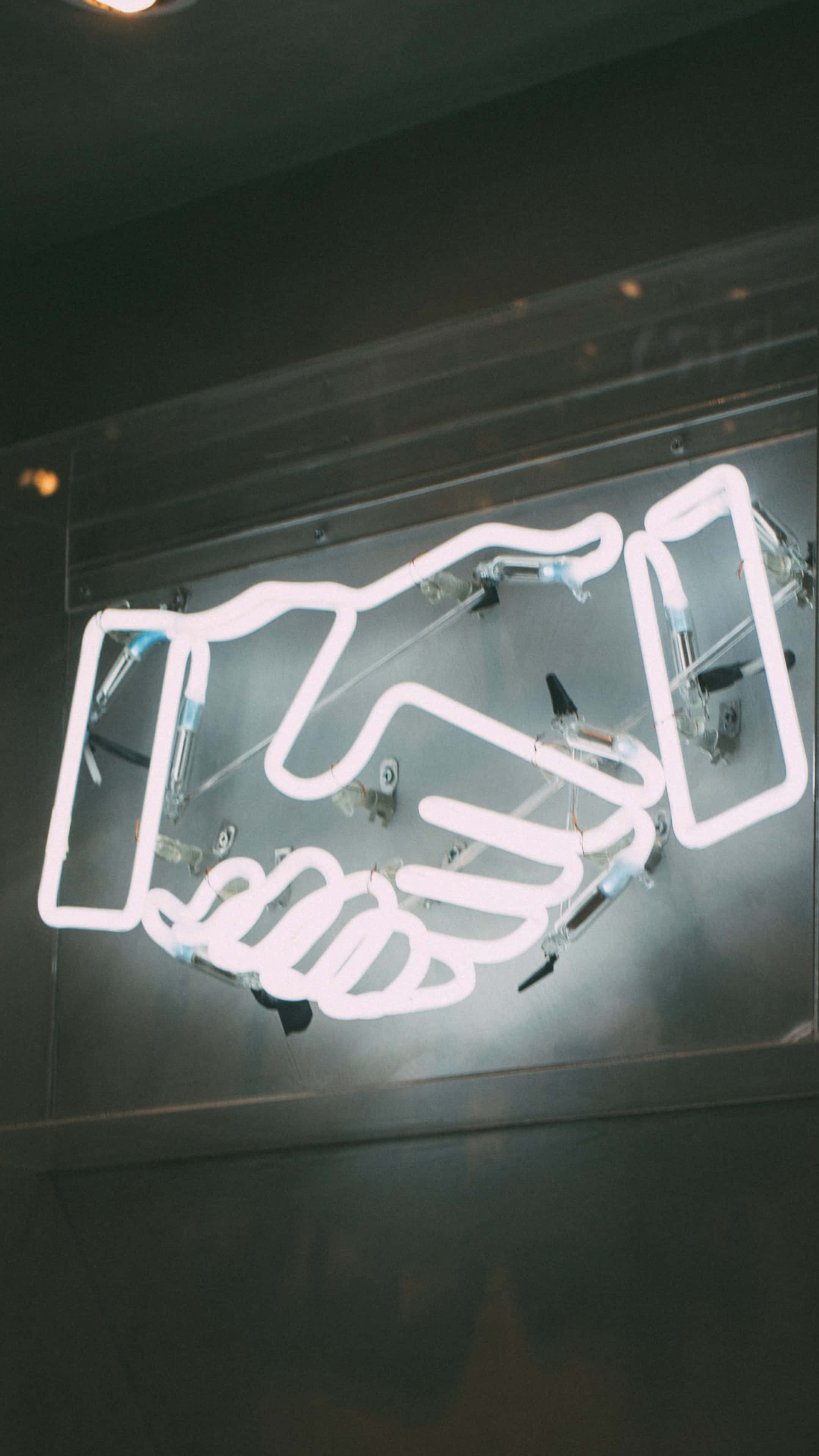 Handshake Neon Sign, glowing white neon, dark metallic wall, 4K Phone Wallpaper