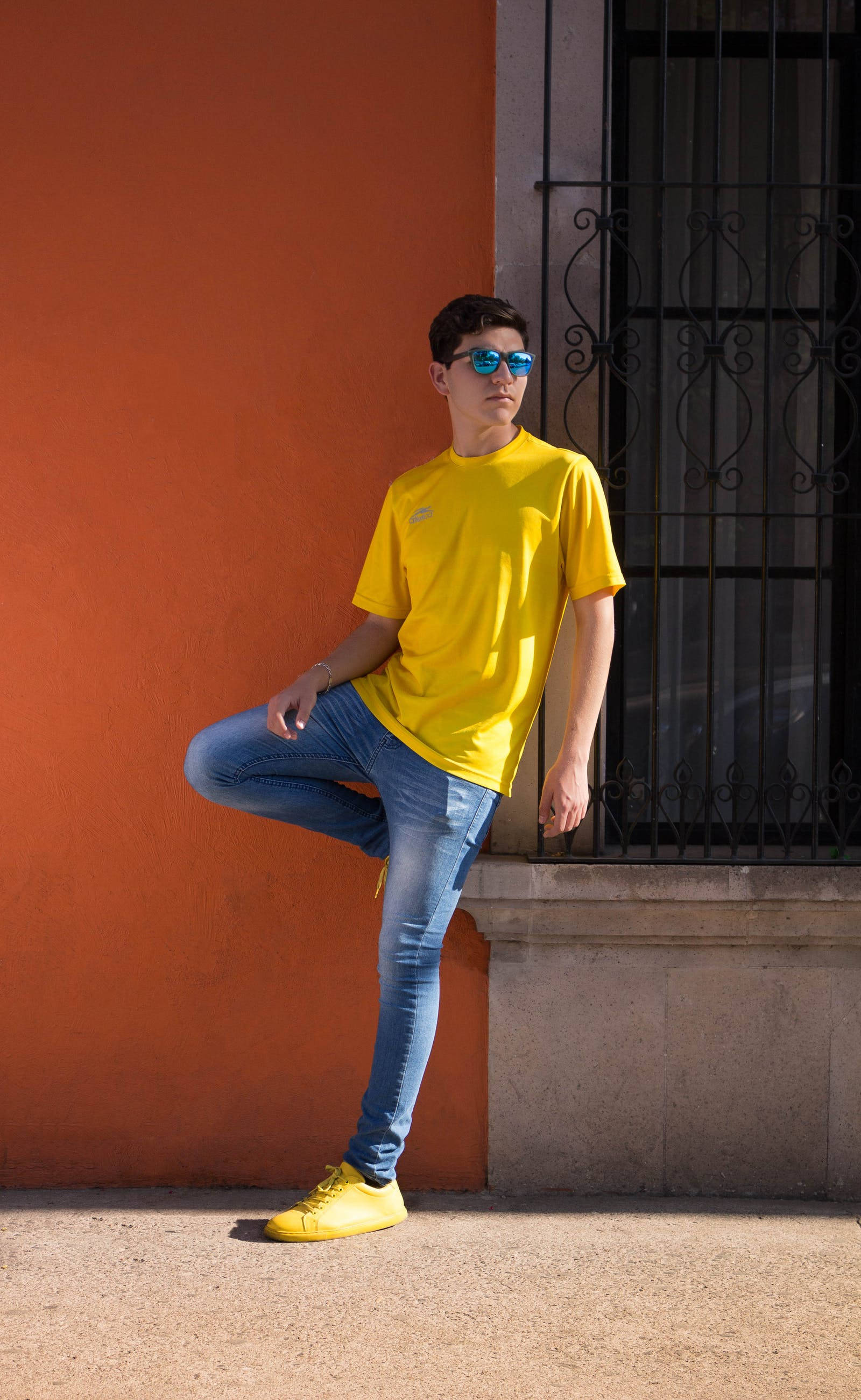 bright yellow shirt, matching sneakers, warm orange wall, 2K Phone Wallpaper