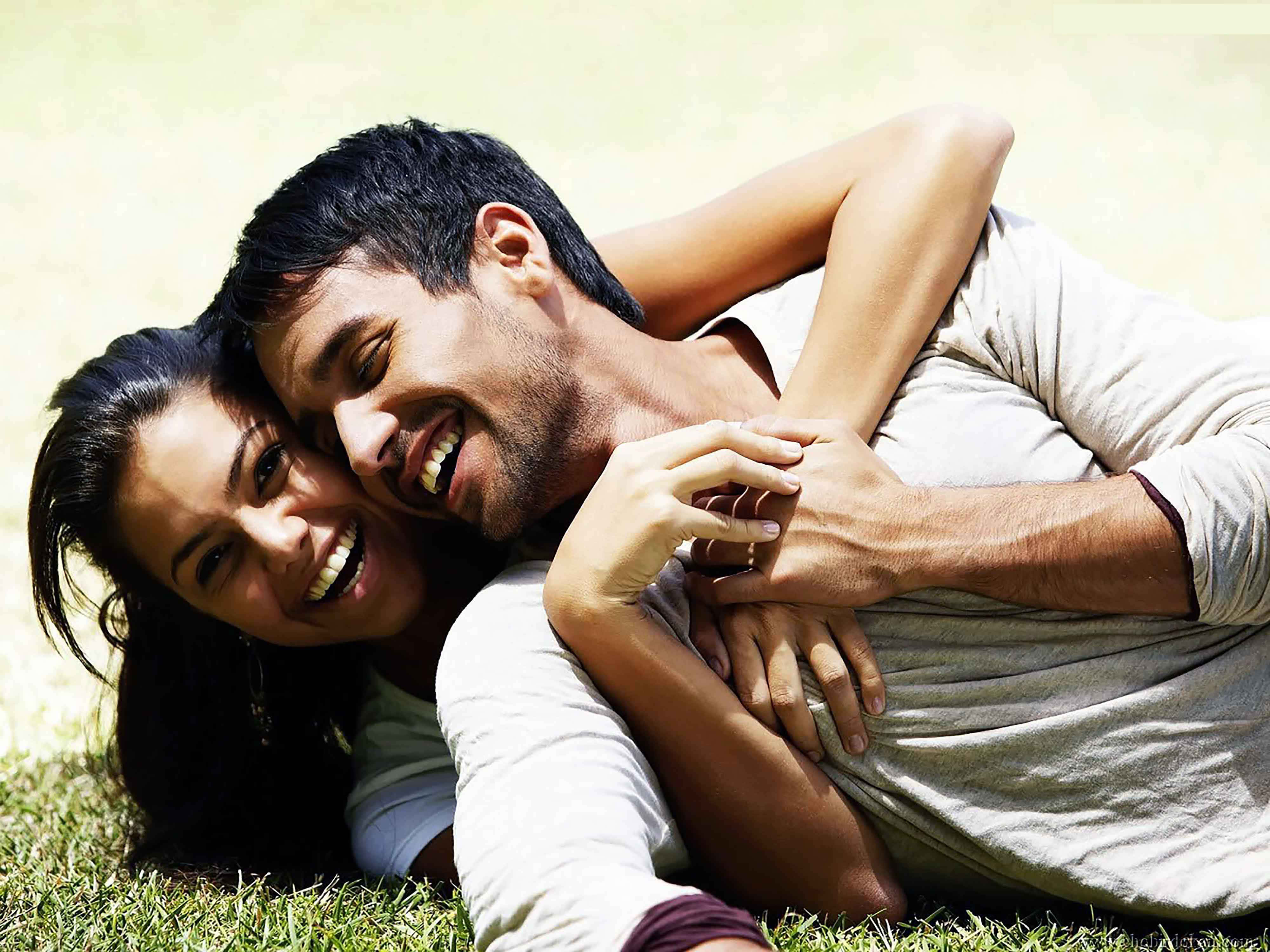 Cherishing Moments Together, joyful couple, sunlit grass, 4K Desktop Wallpaper