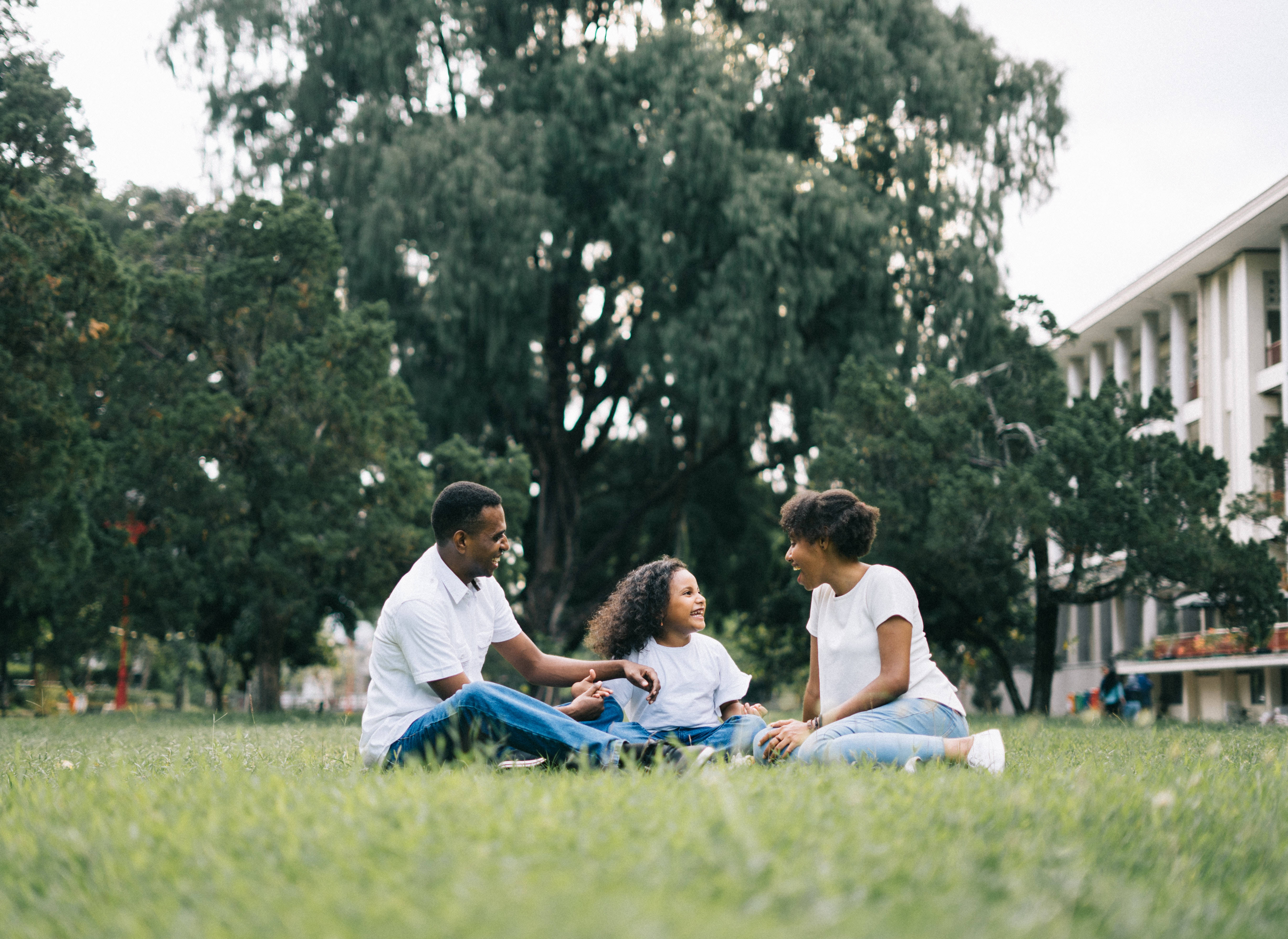 Happy Family In Grass, vibrant green grass, leafy trees, 5K Desktop Wallpaper