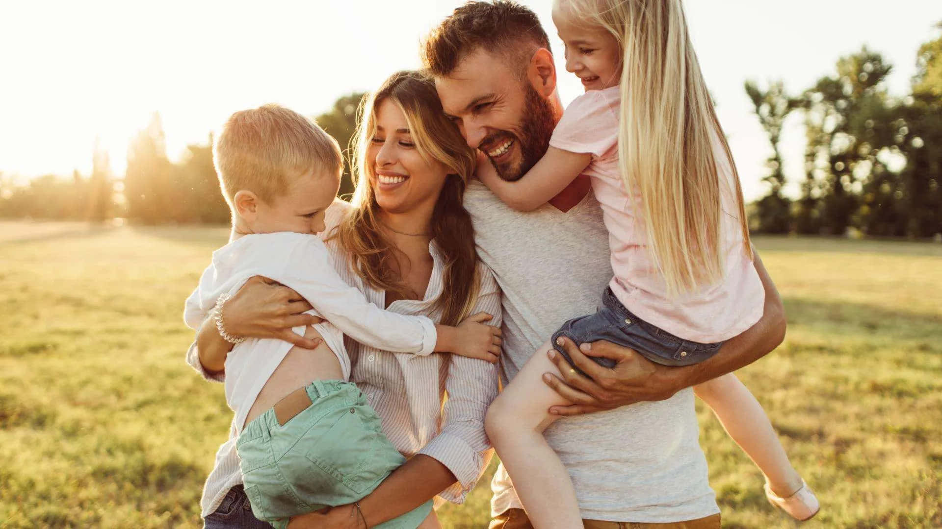 family of four, sunlit grassy field, golden hour, Full HD Desktop Wallpaper