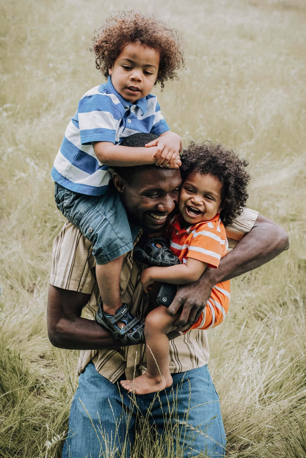joyful father, two smiling curly-haired children, tall golden grass, HD Phone Wallpaper