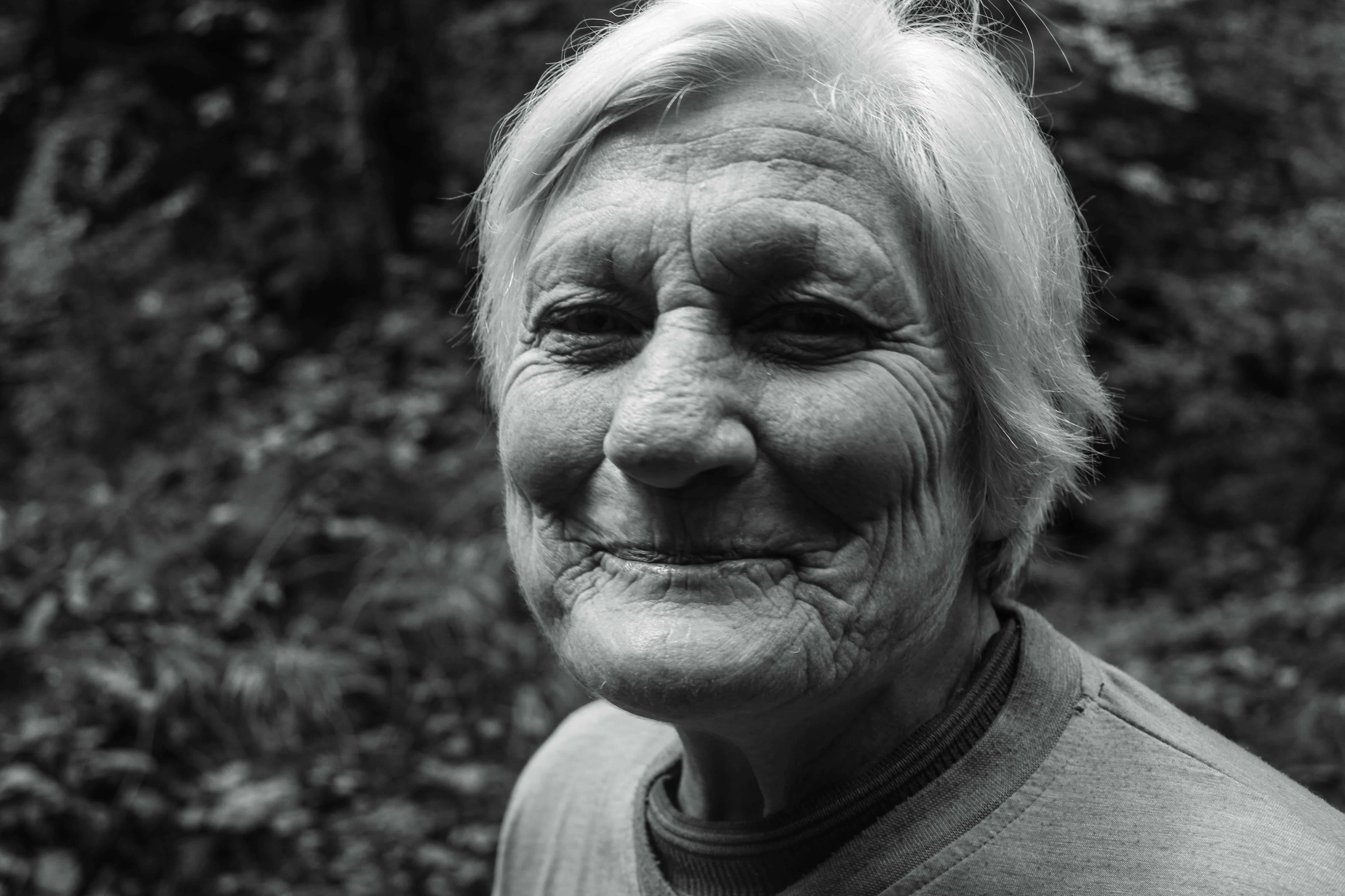 elderly woman, white hair, smiling warmly, 5K Desktop Wallpaper