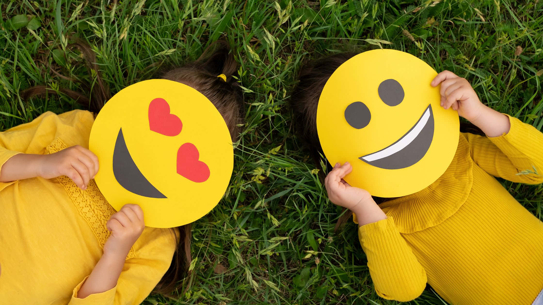 yellow shirts, grass, oversized emoji cutouts, Full HD Desktop Wallpaper