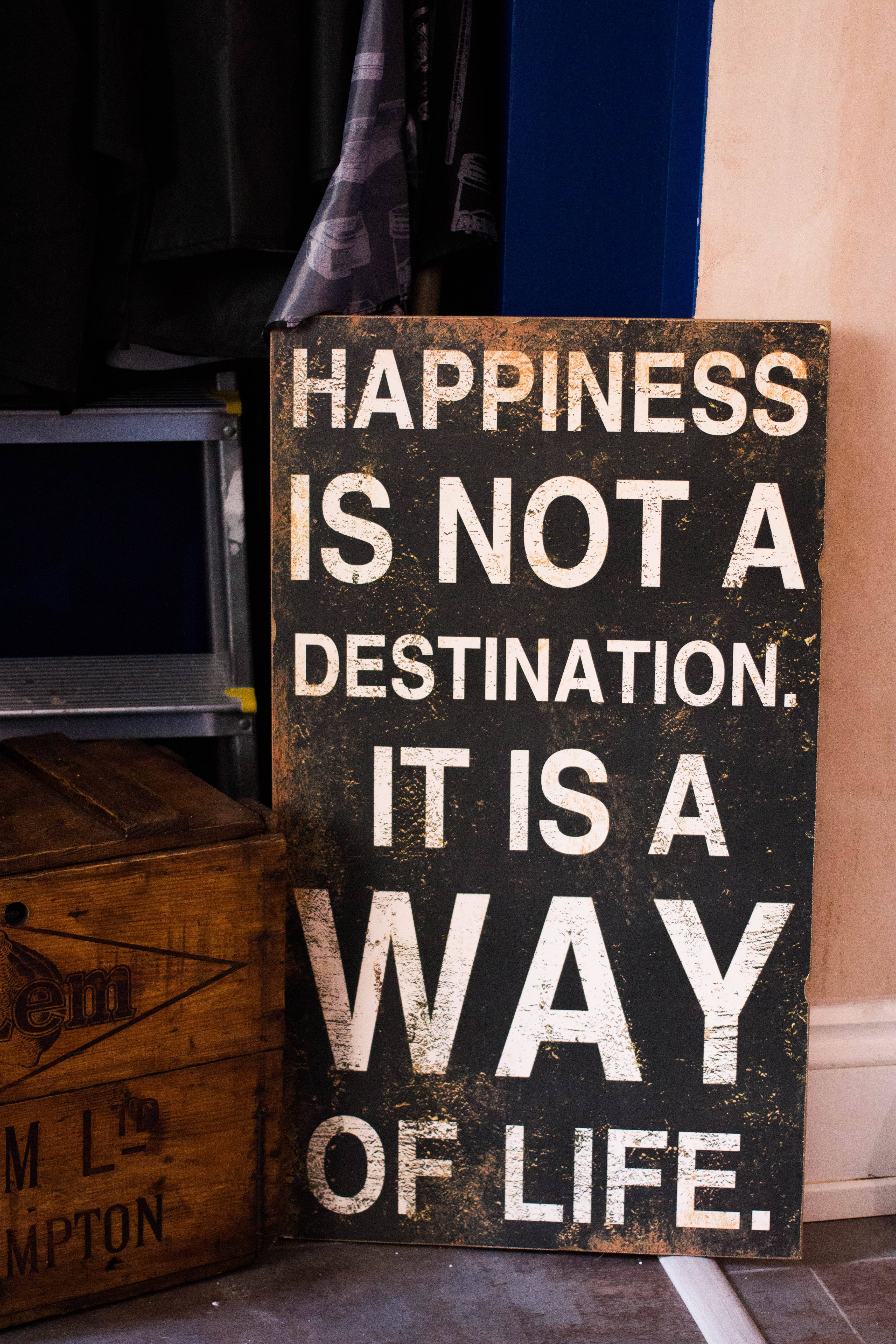 HAPPINESS IS NOT A DESTINATION. IT IS A WAY OF LIFE., black wooden sign, white text, 5K Phone Wallpaper