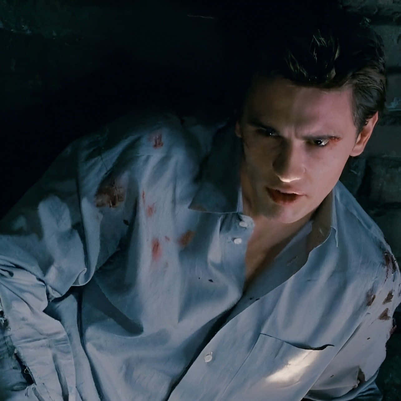 Harry Osborn, bloodied shirt, dimly lit stone surroundings, HD Desktop Wallpaper