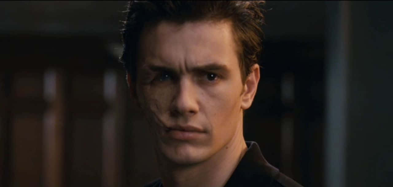 Harry Osborn, scarred cheek, dimly lit indoor setting, HD Desktop Wallpaper