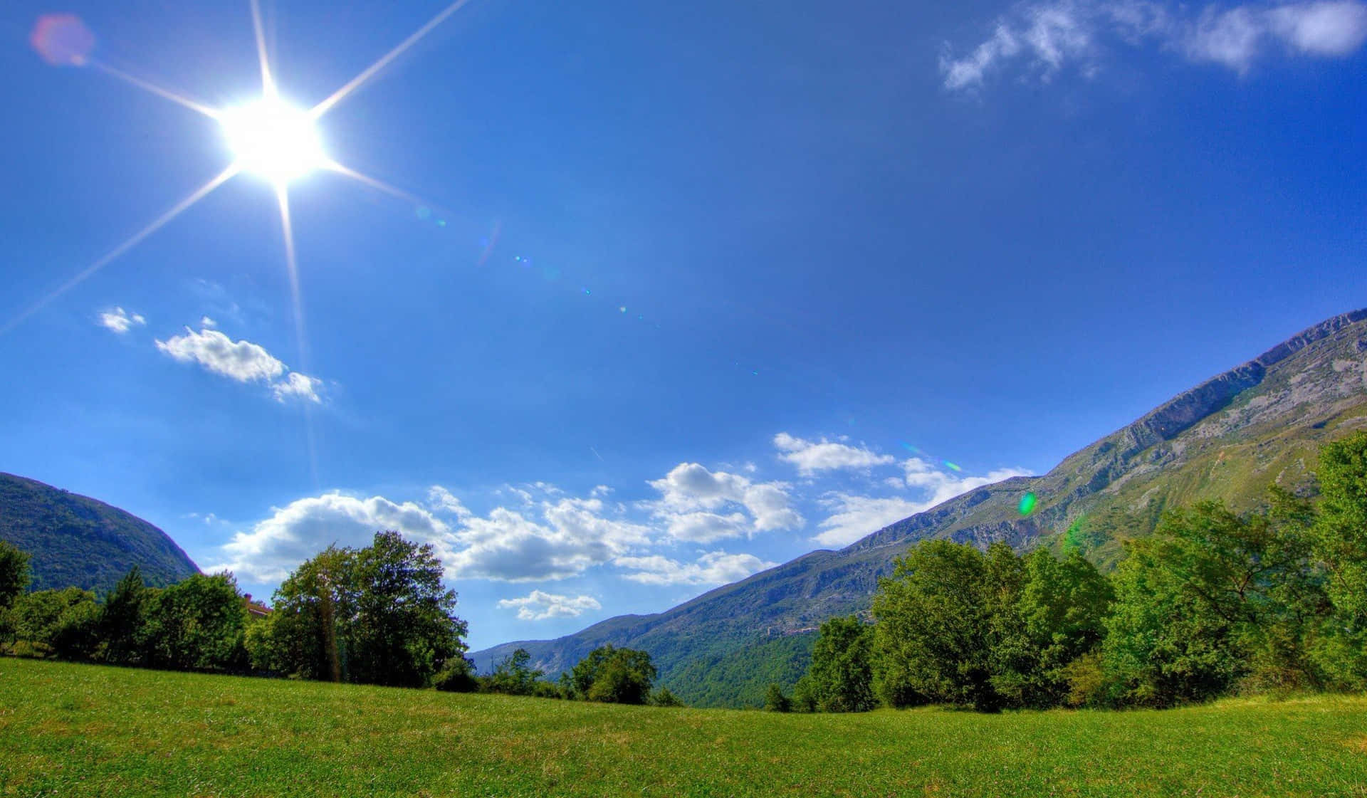 Sunny Day, lush green meadow, forested mountains, Full HD Desktop Wallpaper