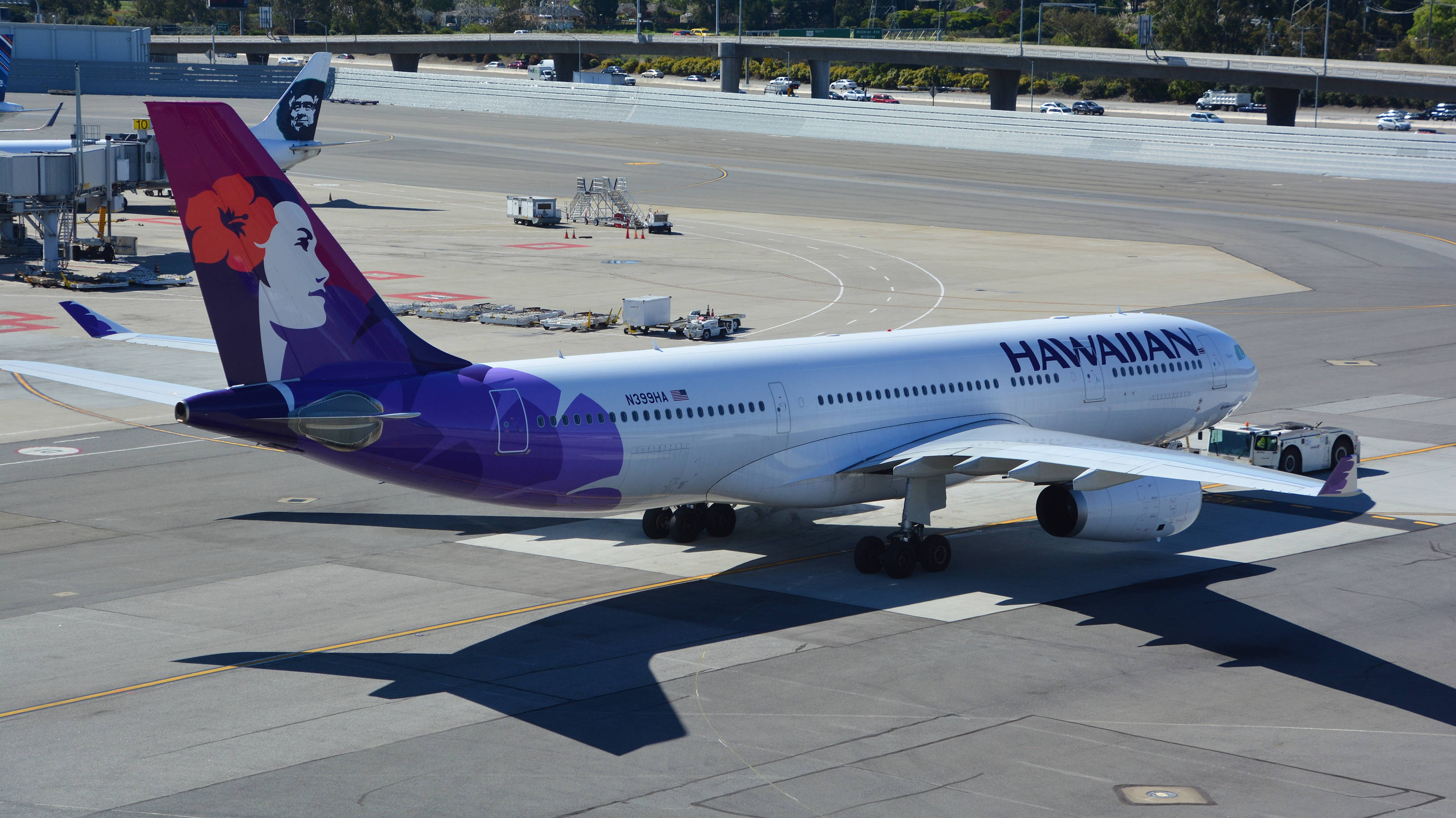 Hawaiian Airlines, purple and white livery, sunny airport tarmac, 2K Desktop Wallpaper
