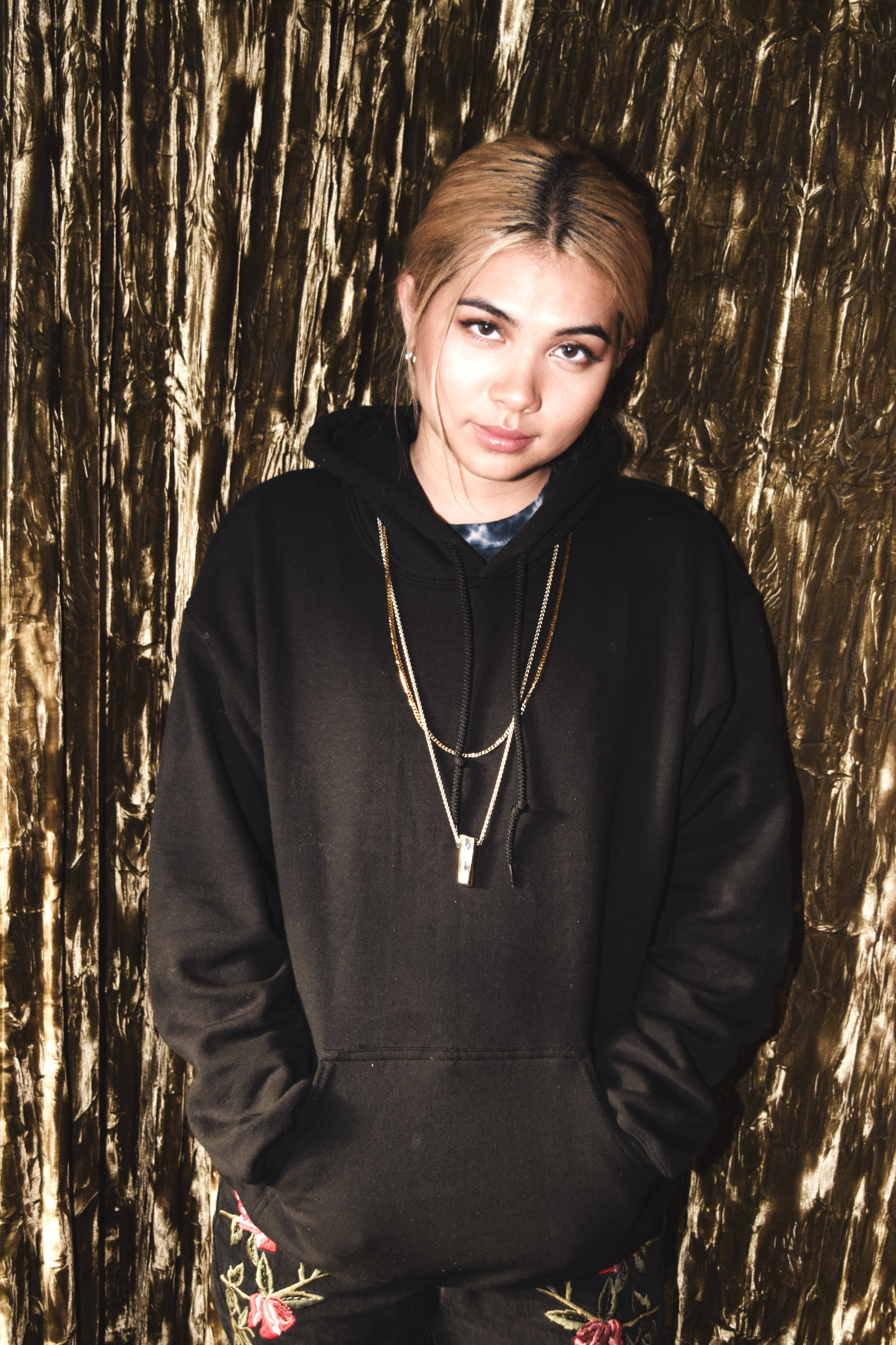 Hayley Kiyoko, black hoodie, shimmering gold foil backdrop, 5K Phone Wallpaper