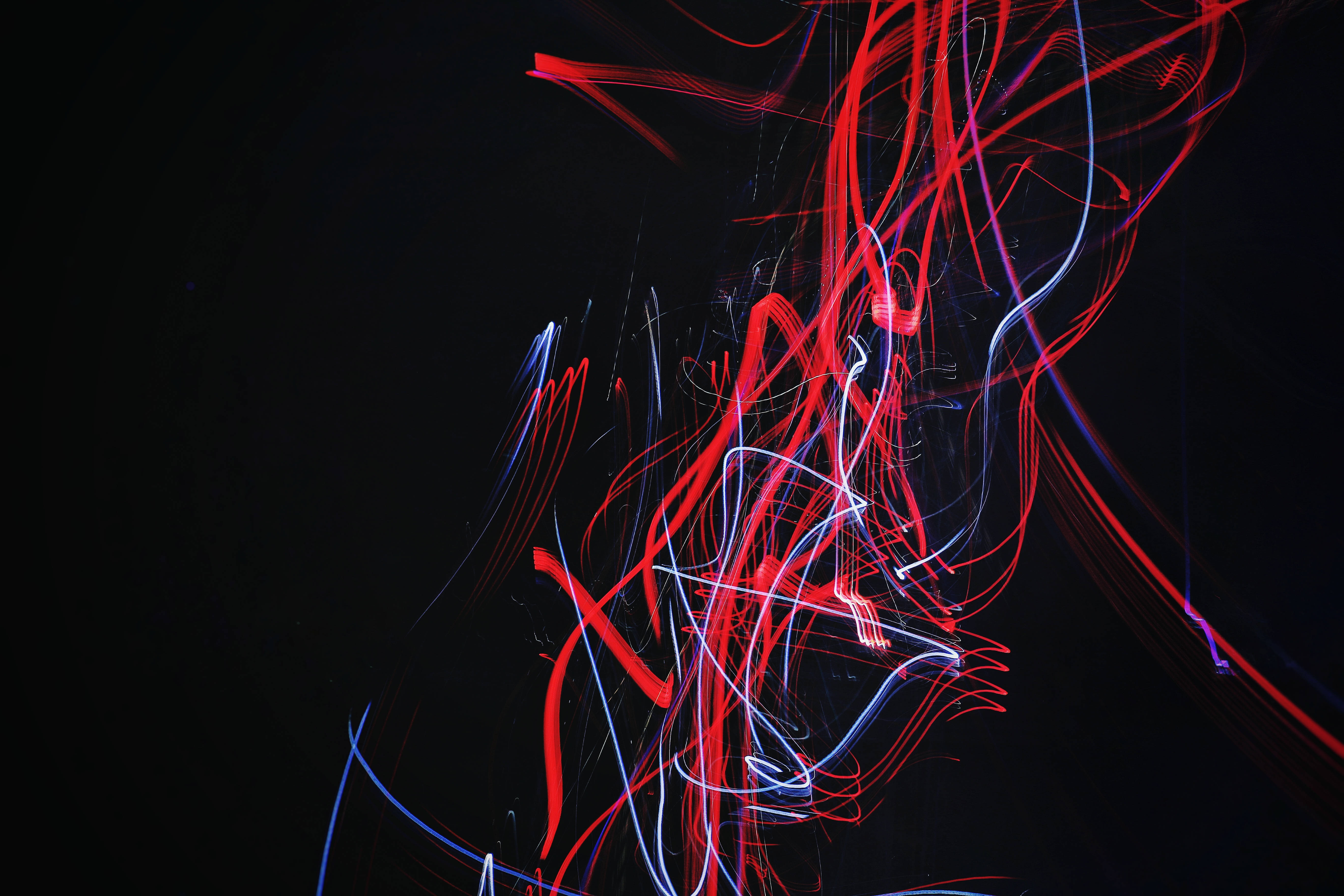 vibrant red, blue light trails, deep black background, 5K Desktop Wallpaper