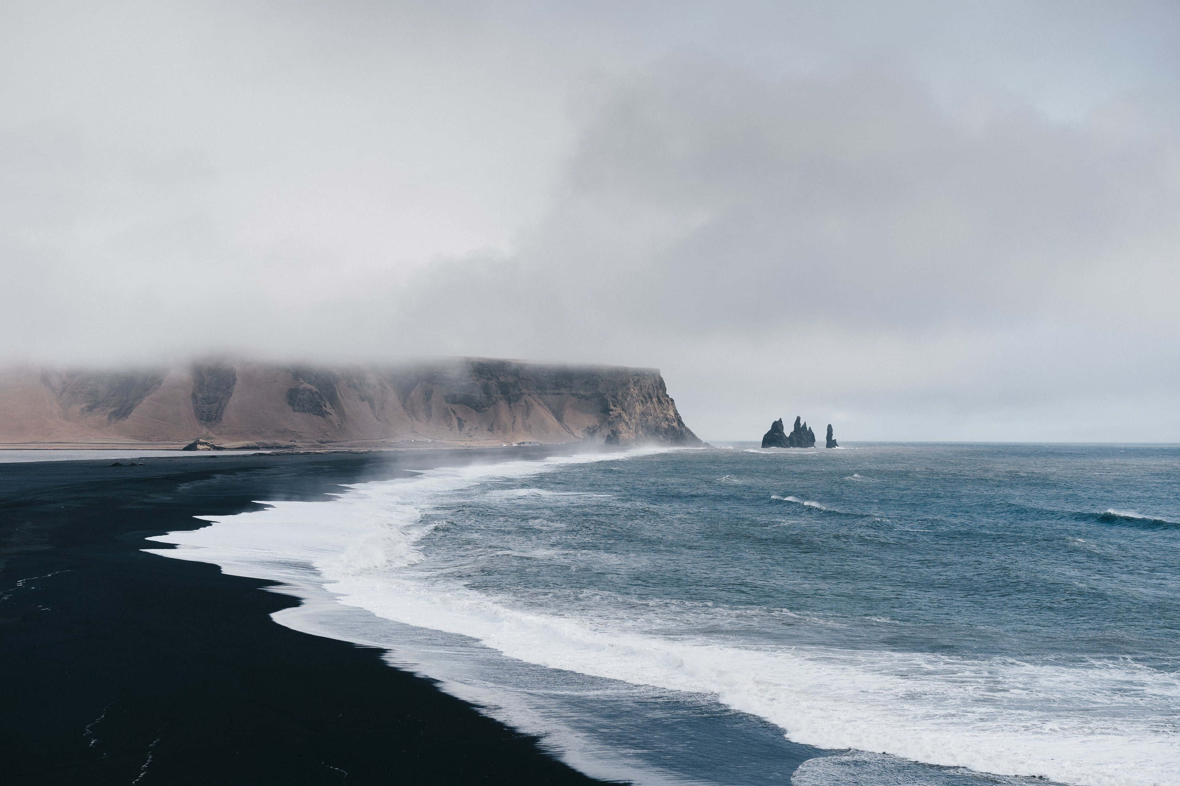 black sand beach, misty cliffs, dark volcanic shores, 4K Desktop Wallpaper