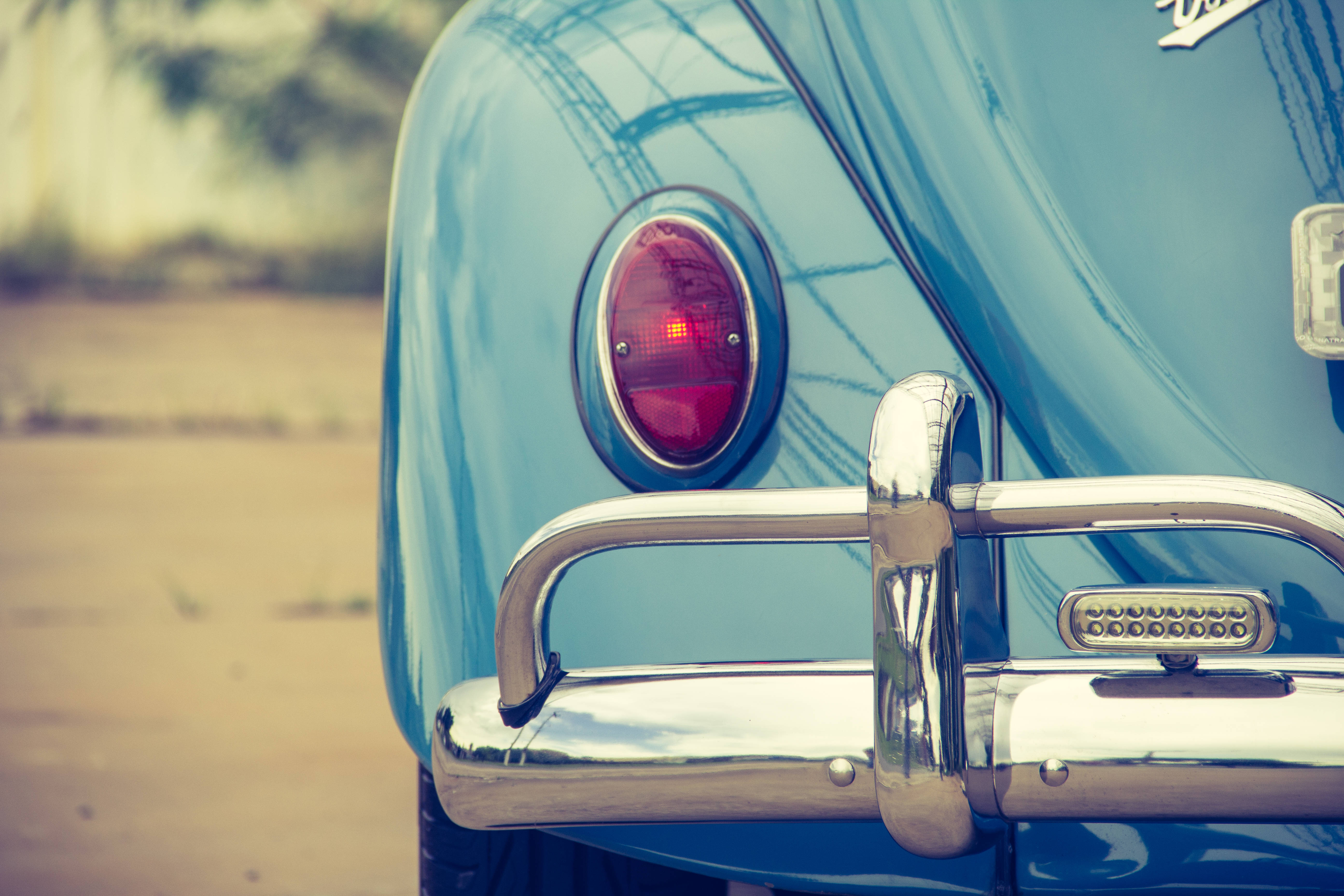 vintage light blue car, chrome bumper, glowing red taillight, 5K Desktop Wallpaper