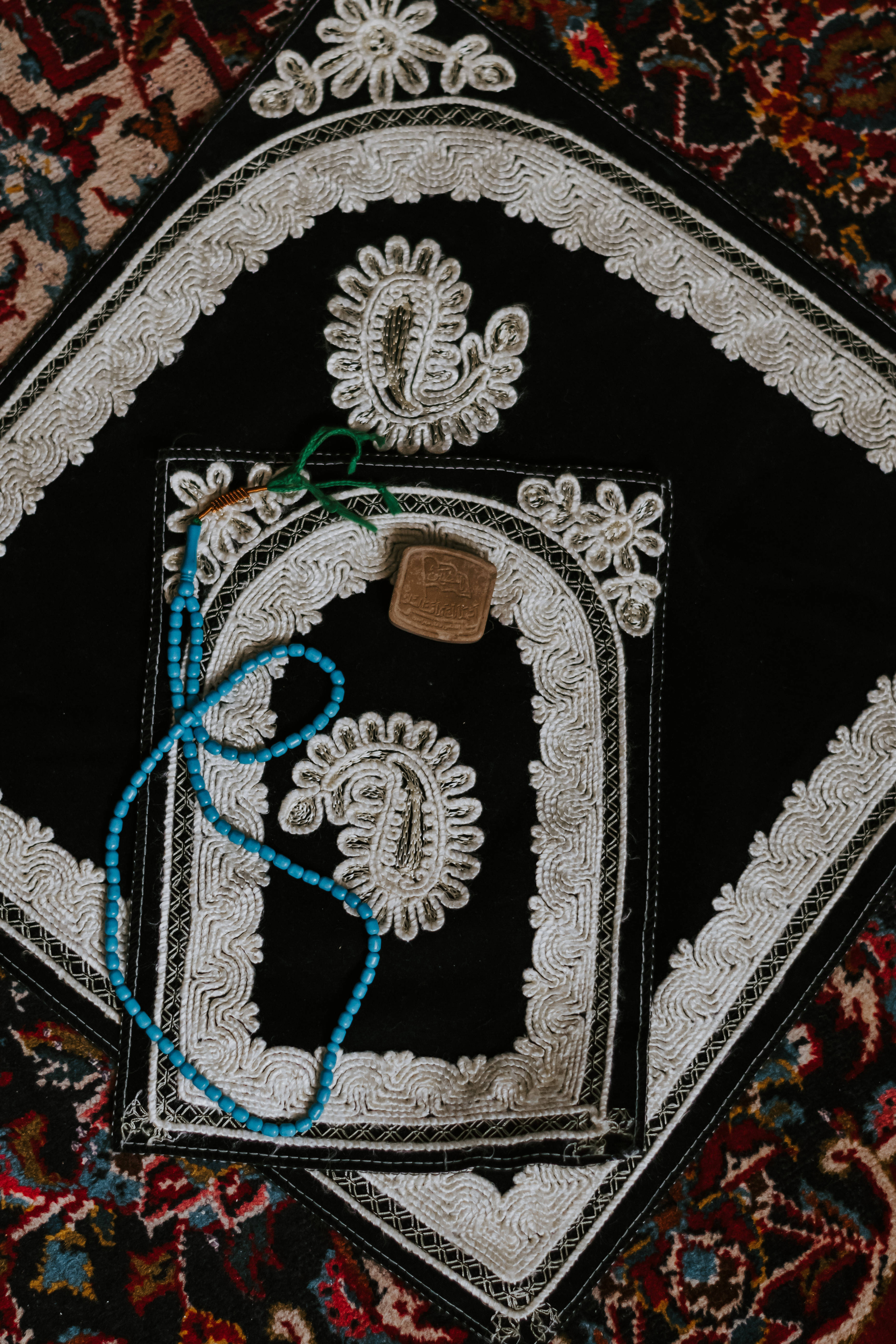 Tasbih For Allah, black prayer rug, intricate white embroidery, 5K Phone Wallpaper