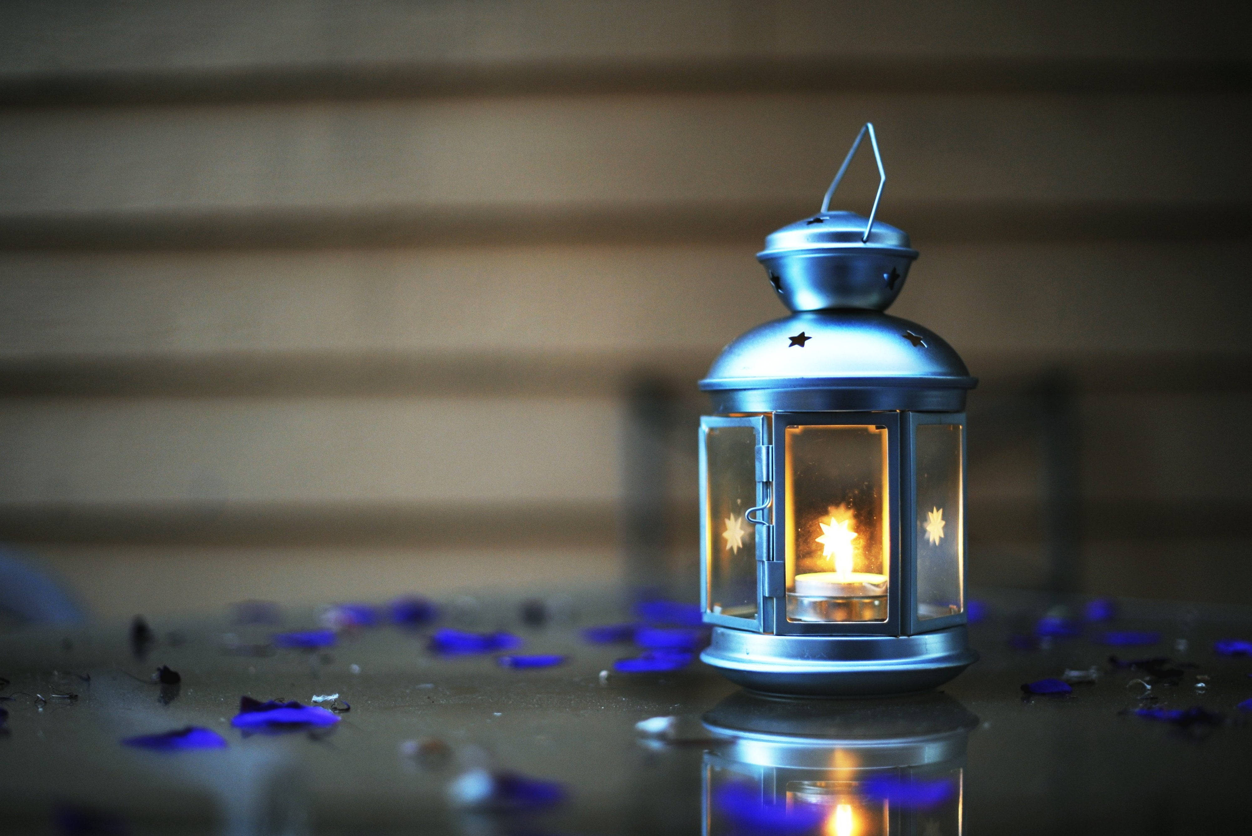 silver lantern, glowing candle, reflective surface, 4K Desktop Wallpaper