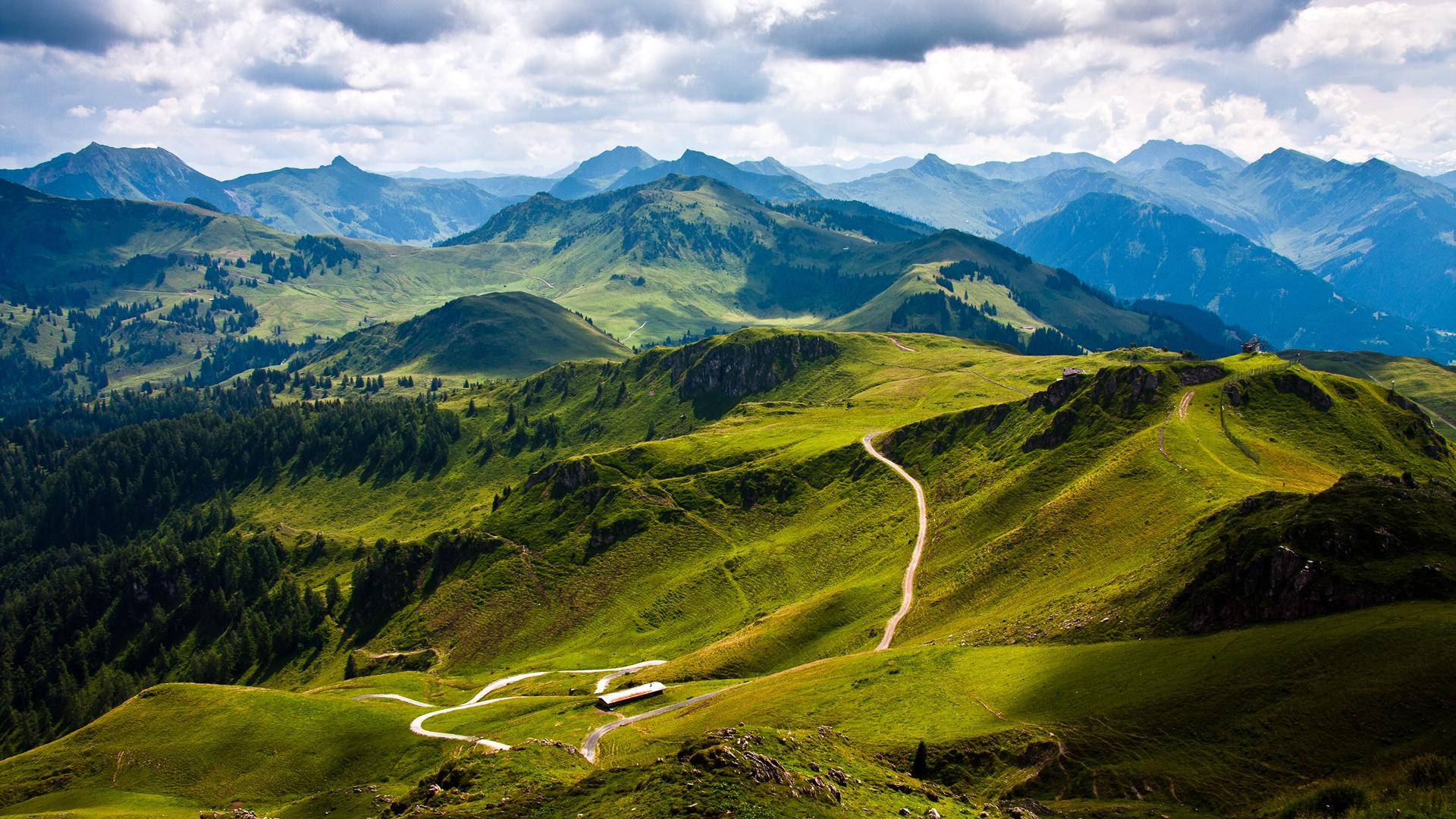 mountain road, vibrant green mountain valleys, dramatic cloudy sky, Full HD Desktop Wallpaper