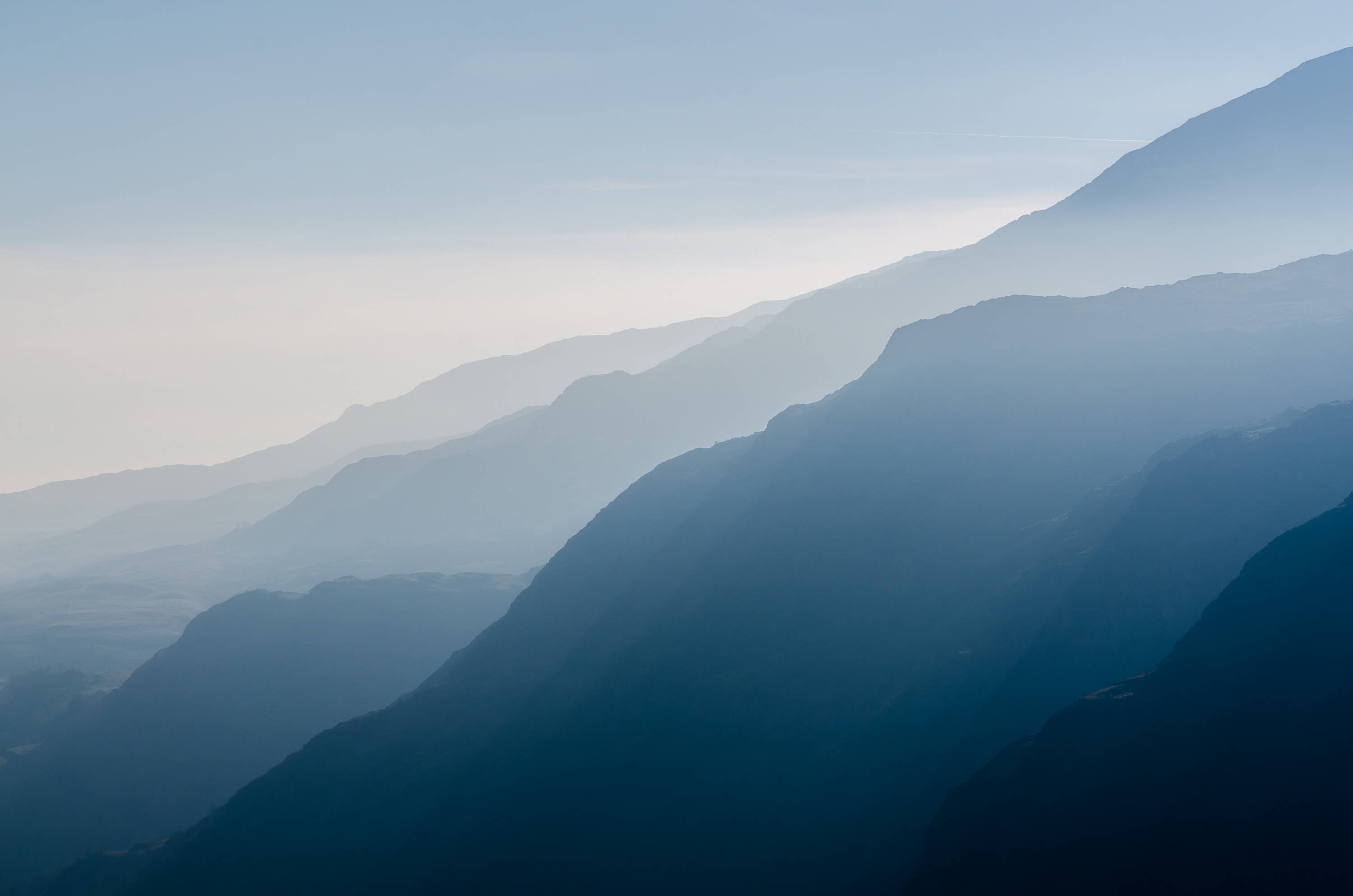 majestic sunrise, snow-capped peaks, layered mountain ridges, 2K Desktop Wallpaper