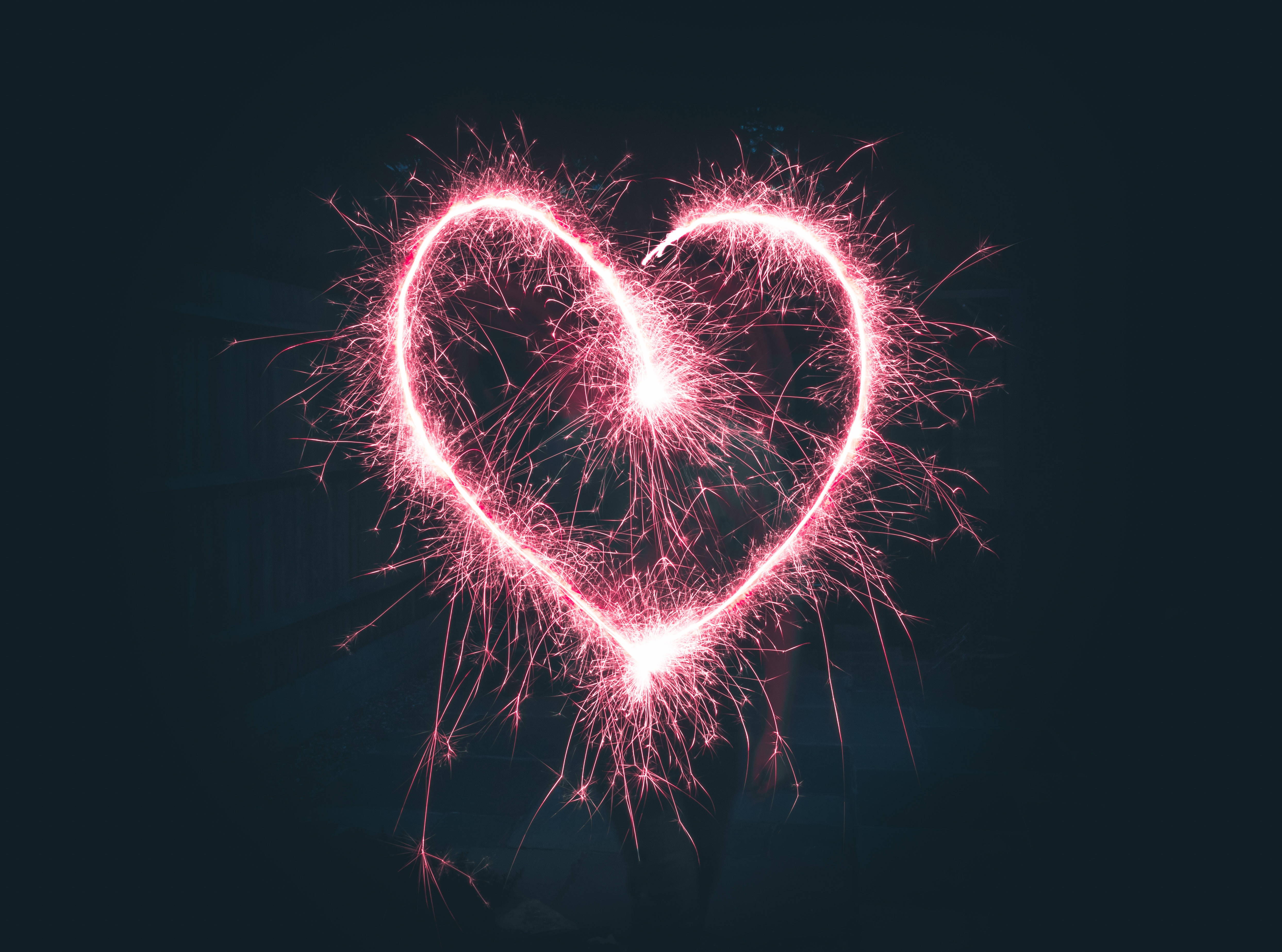glowing pink heart-shaped sparkler, fiery sparks, dark night sky, 4K Desktop Wallpaper