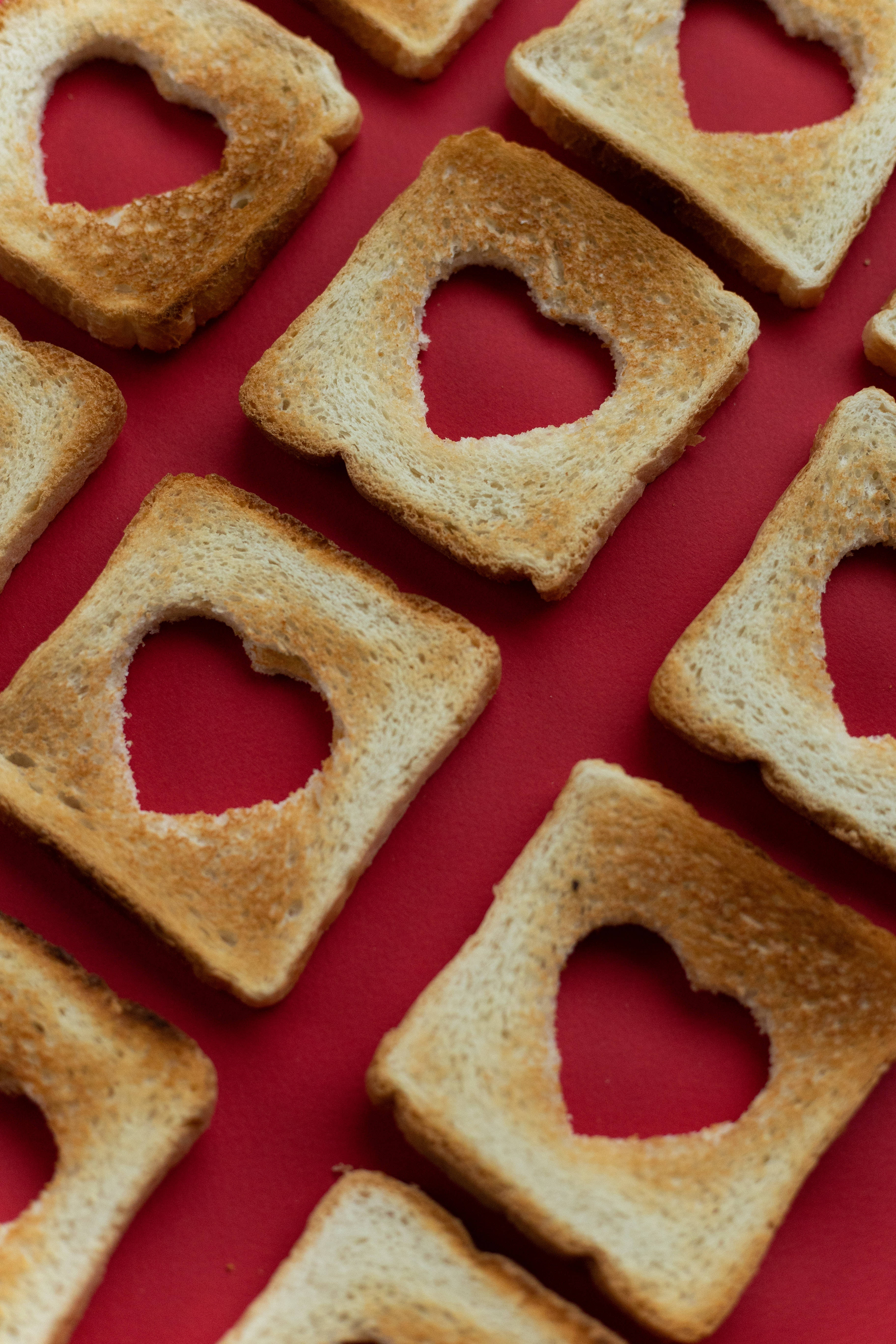 Heart iPhone, golden toasted bread slices, heart-shaped holes, 5K Phone Wallpaper