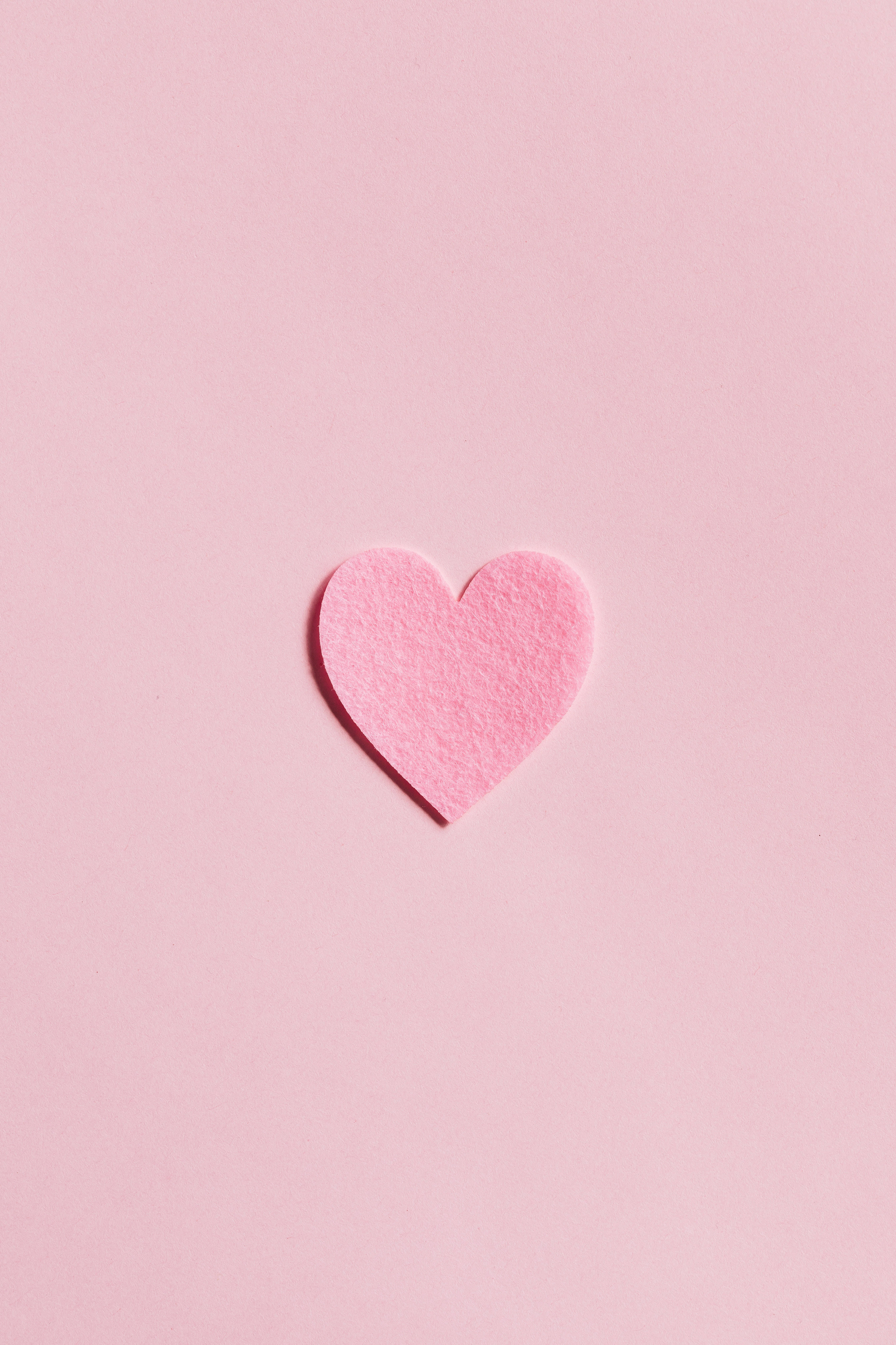 Heart iPhone, soft pink felt heart, pastel pink surface, 5K Phone Wallpaper