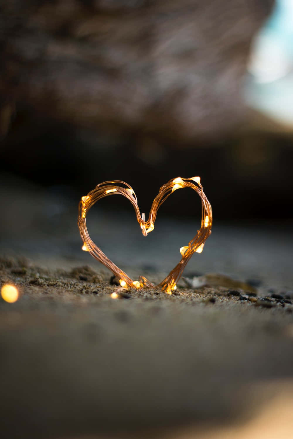 heart shape, glowing string of warm lights, textured sand, HD Phone Wallpaper