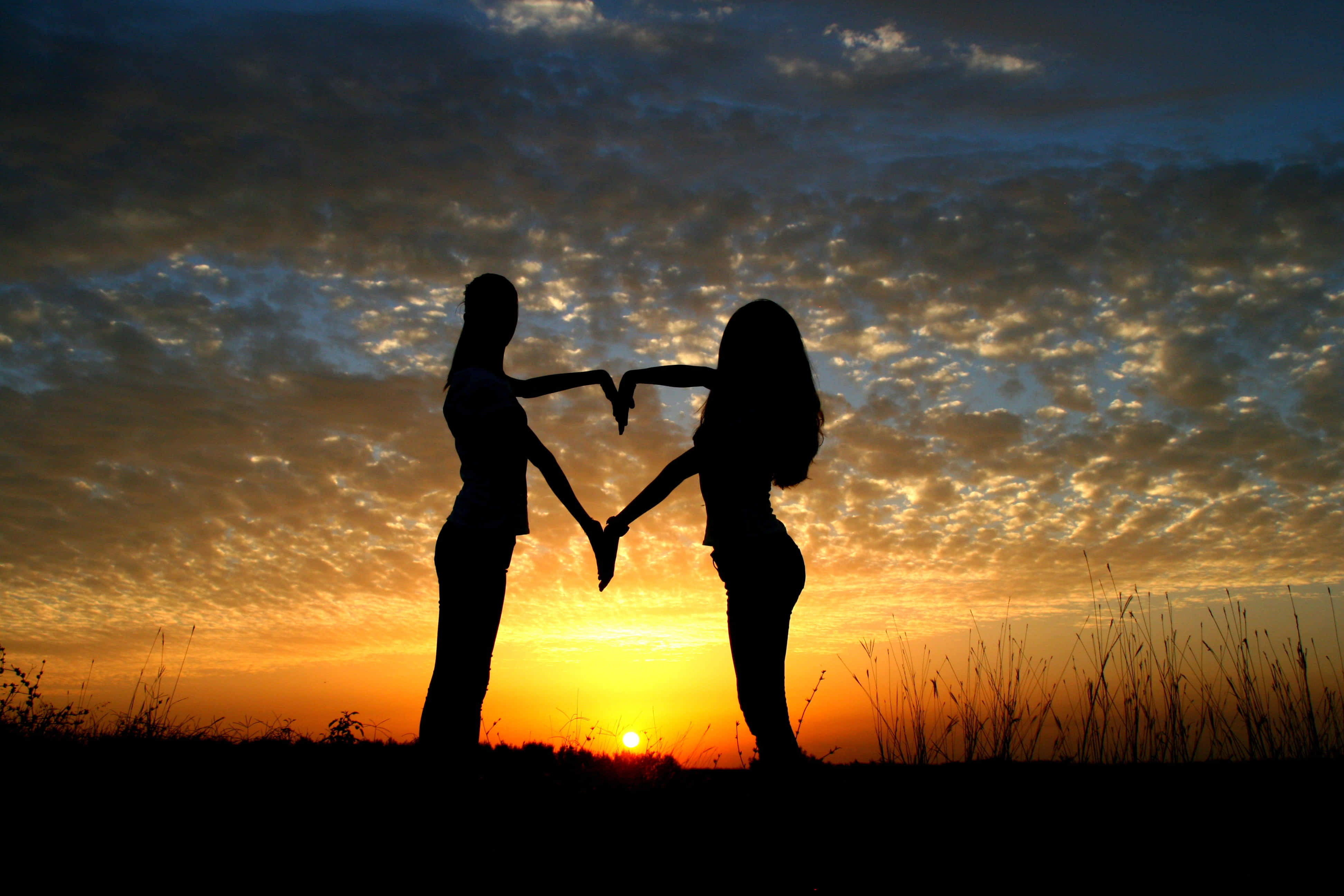 heart silhouette, vibrant sunset, textured clouds, 4K Desktop Wallpaper