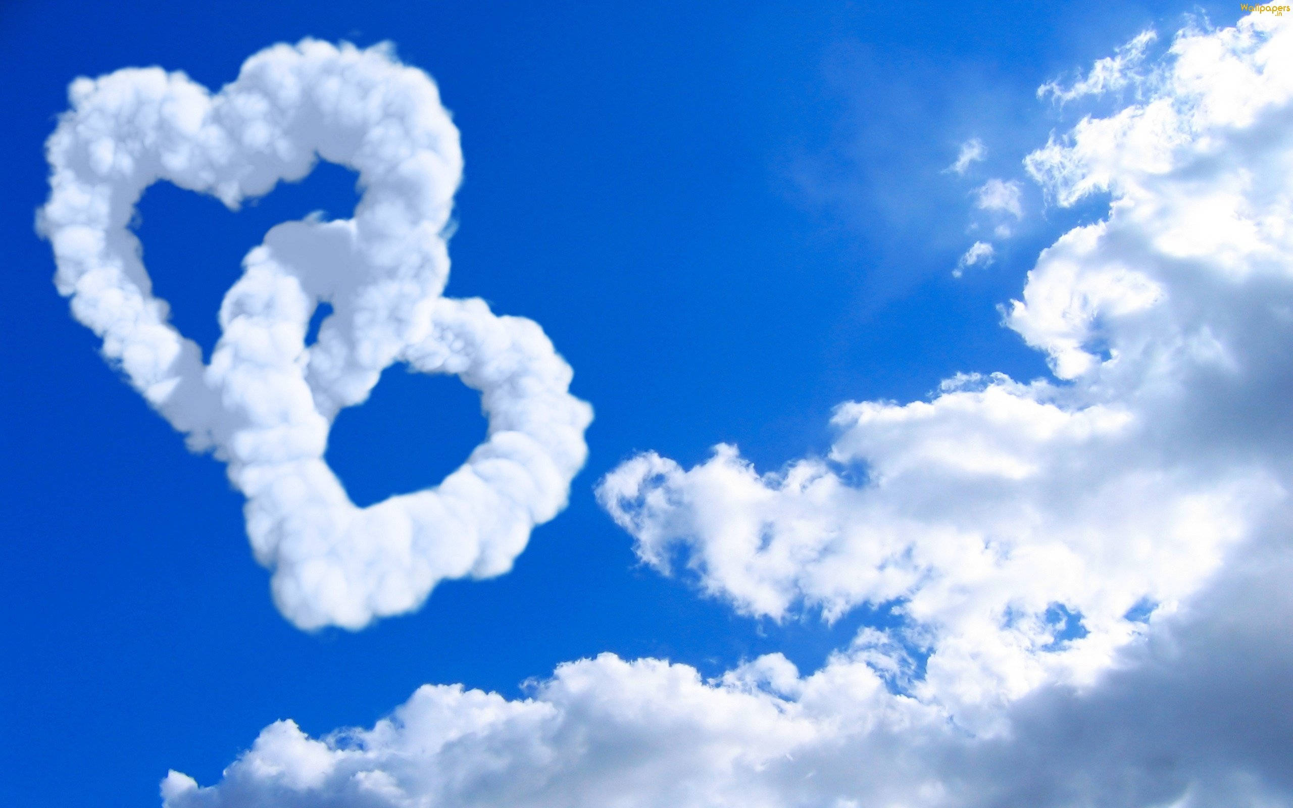 Heavenly Clouds, fluffy white heart-shaped clouds, vibrant blue sky, 2K Desktop Wallpaper