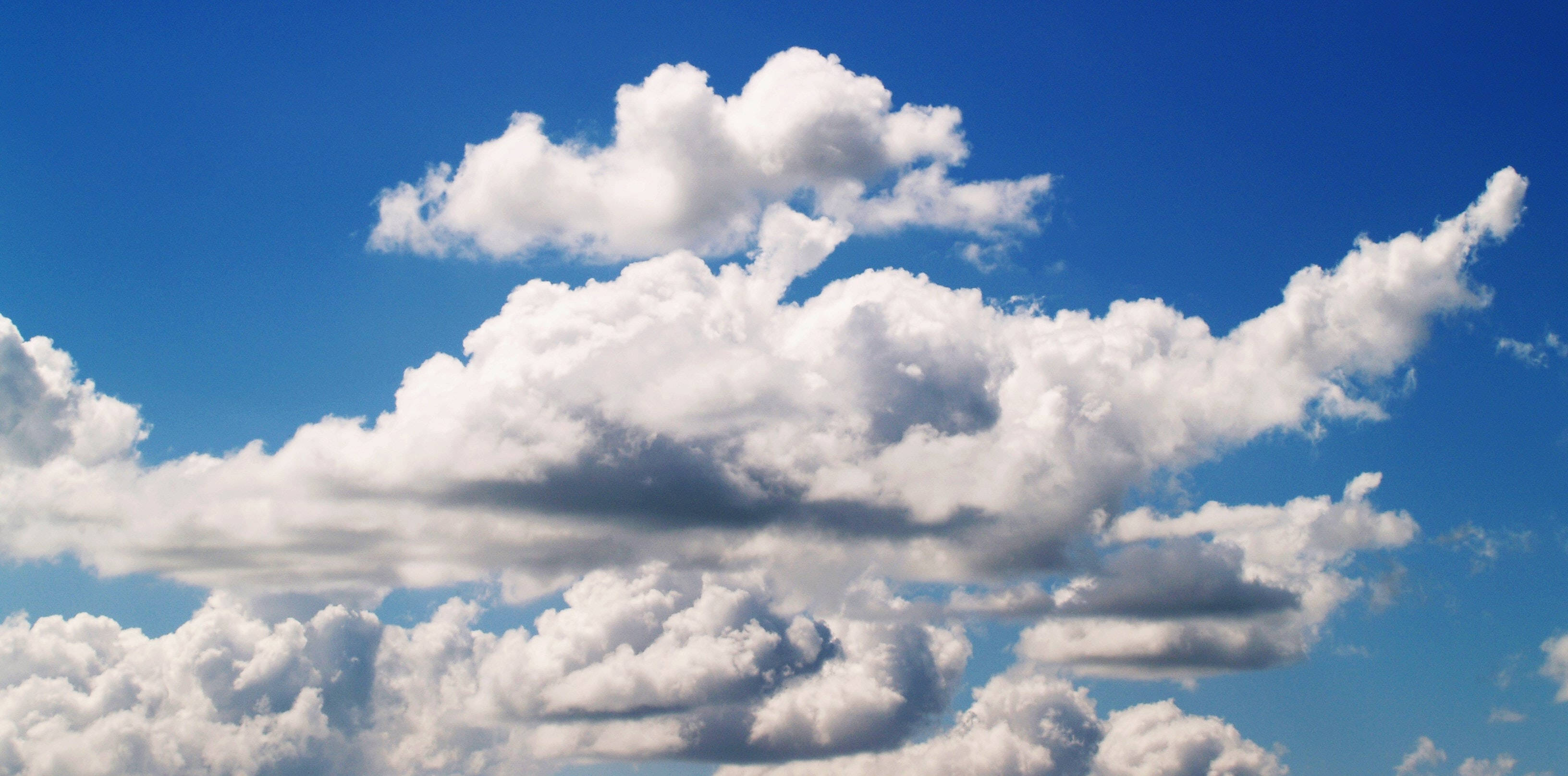 blue sky, white cumulus clouds, soft shadows, 2K Desktop Wallpaper
