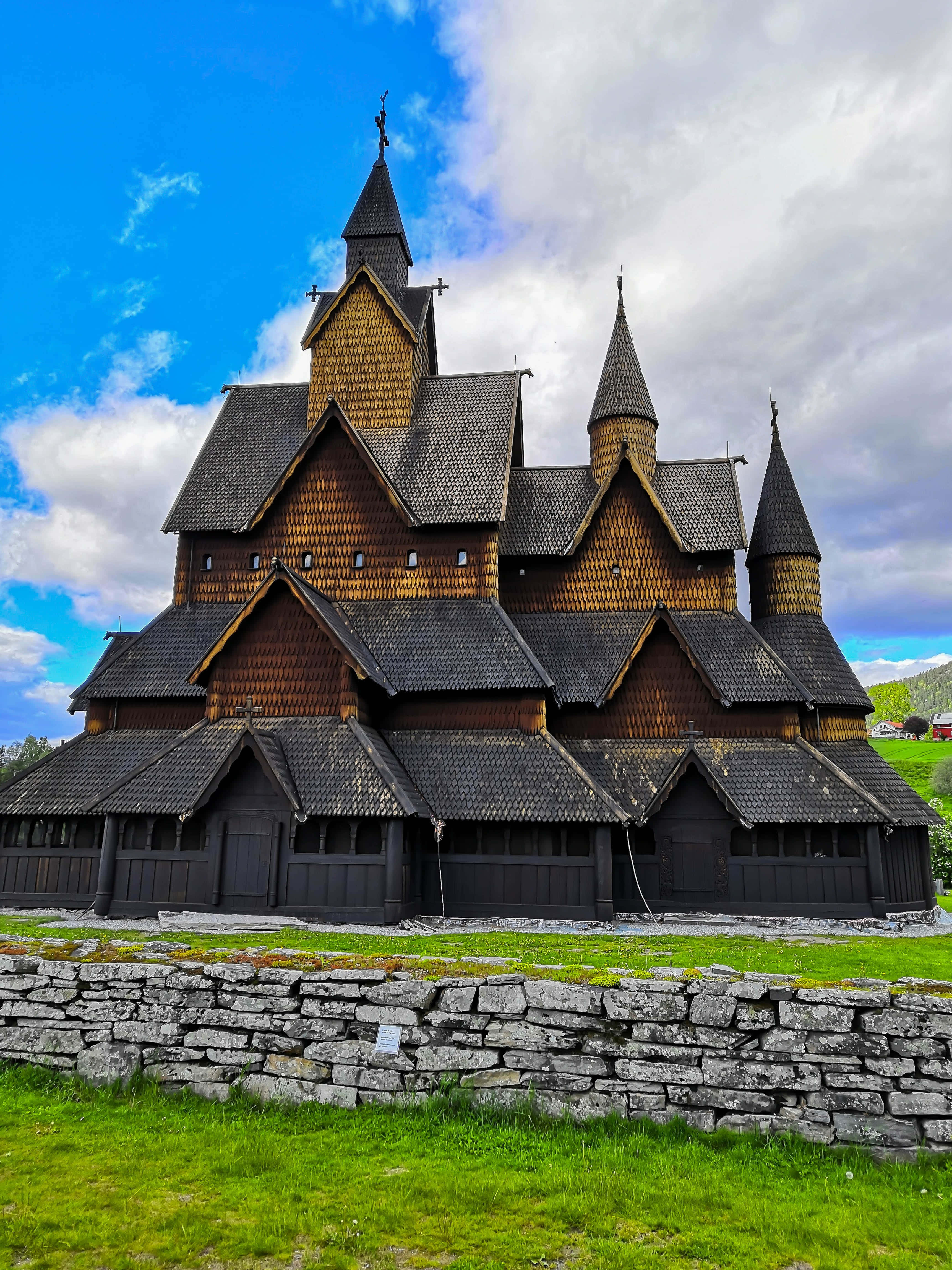 Heddal Stave Church, dark shingled roofs, pointed spires, 4K Phone Wallpaper