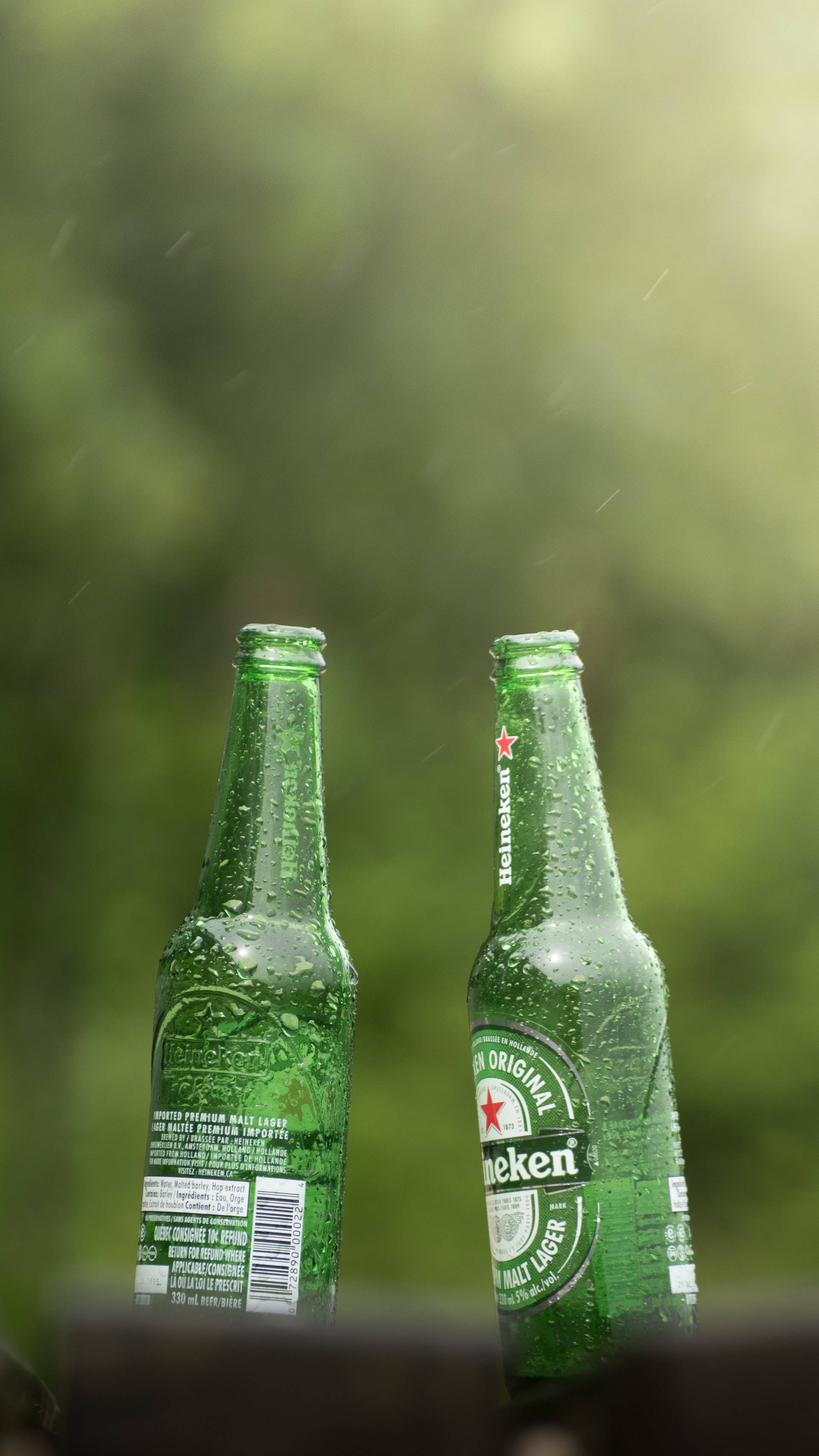 Heineken, lager beer bottles, green blurred background, 2K Phone Wallpaper