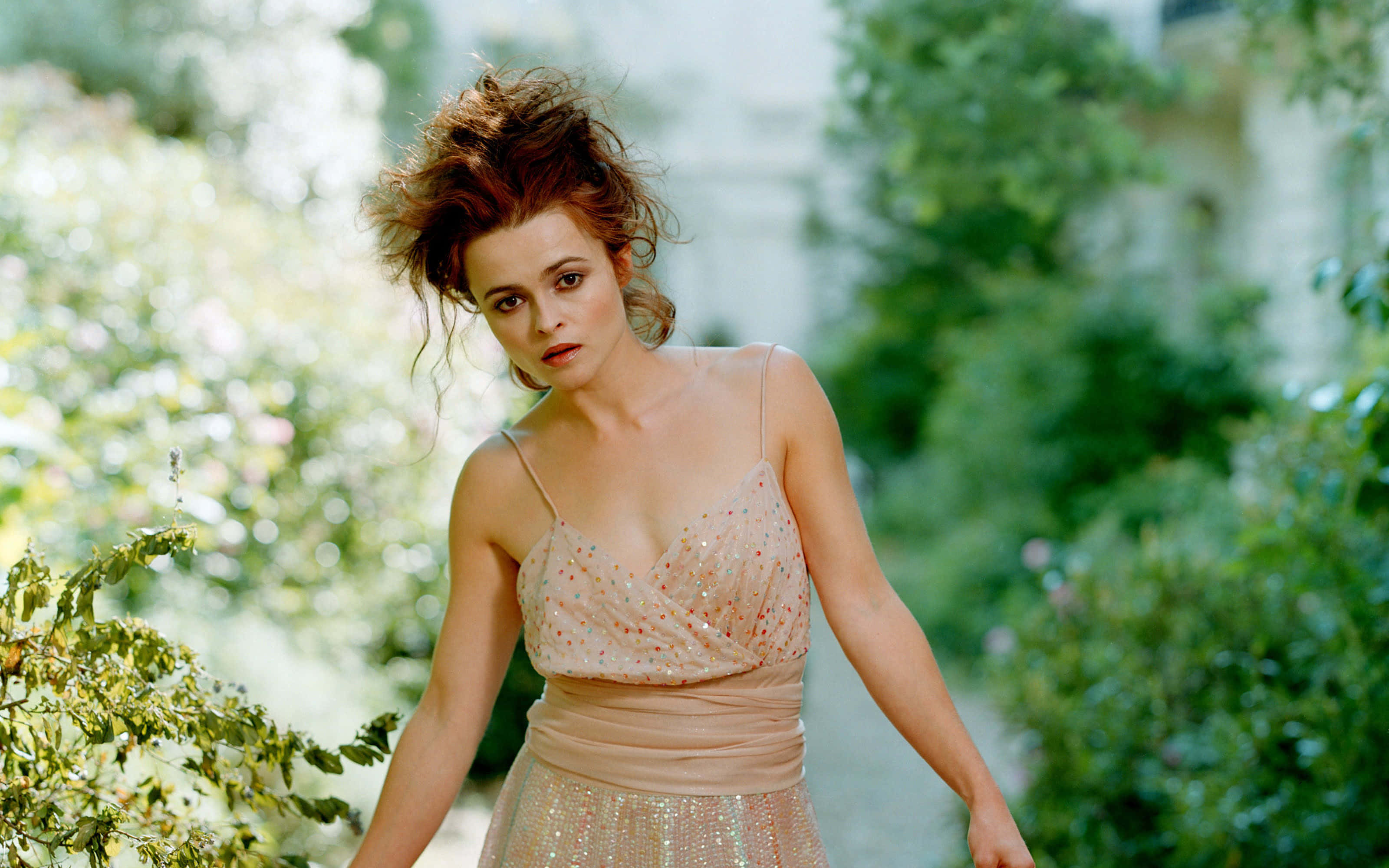 Helena Bonham Carter, shimmering peach dress, lush green foliage, 2K Desktop Wallpaper