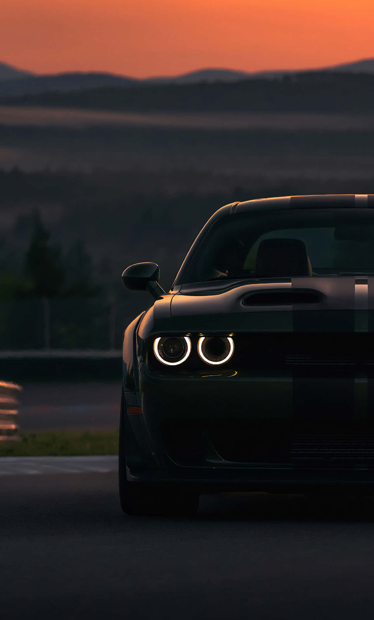 Hellcat iPhone, sleek black muscle car, glowing circular headlights, Full HD Phone Wallpaper