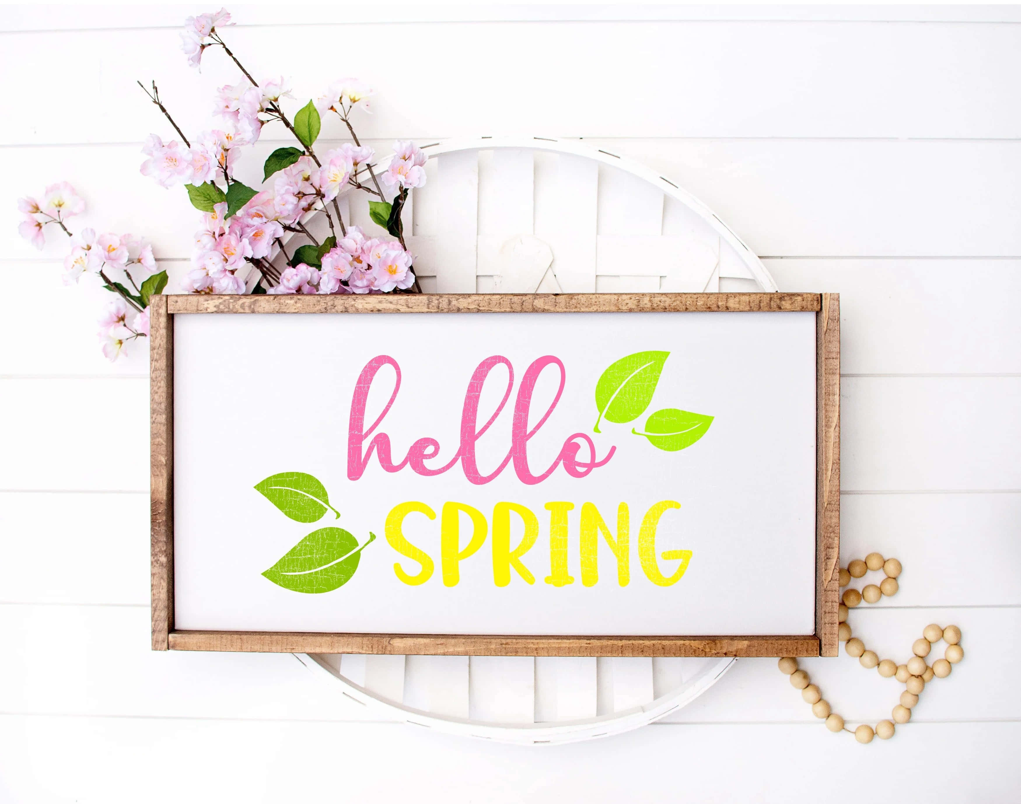 hello spring sign, pink and yellow text, green leaves, 2K Desktop Wallpaper