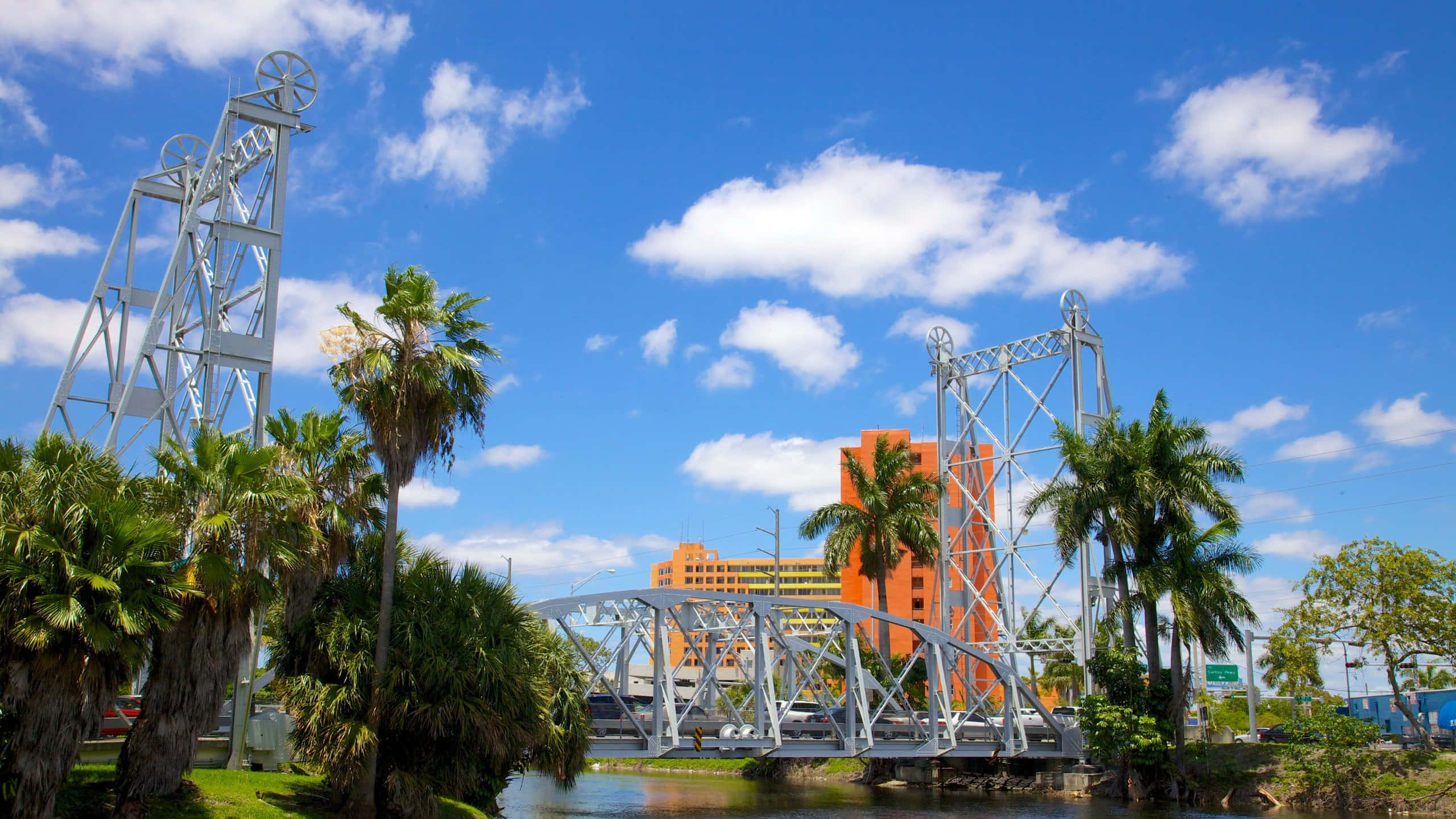 Hialeah skyline, silver truss bridge, calm river, 2K Desktop Wallpaper