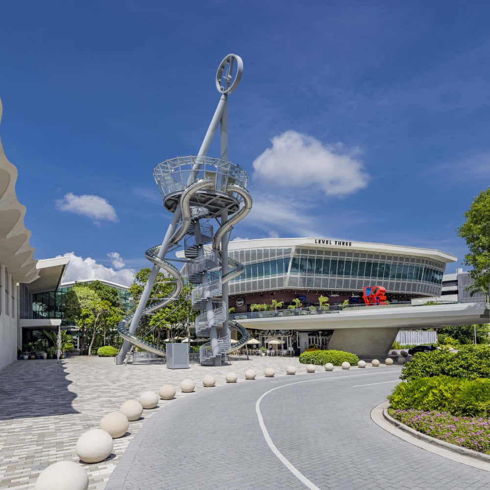 modern spiral slide sculpture, curved glass building, bright blue sky, SD Desktop Wallpaper