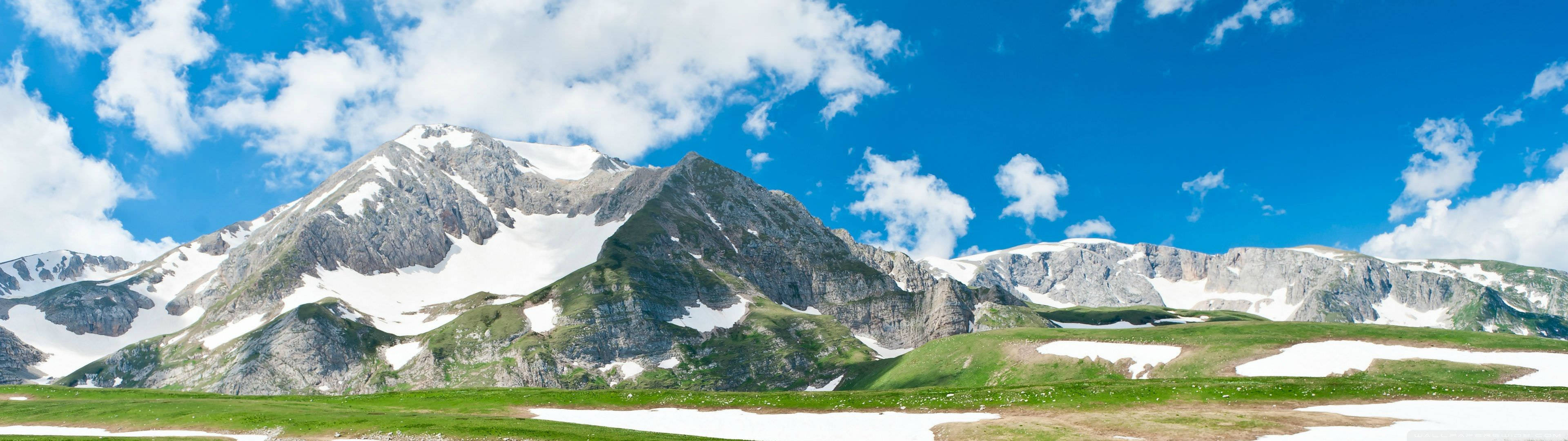 mountain pasture, snow-capped mountain peaks, bright blue sky, 4K Desktop Wallpaper