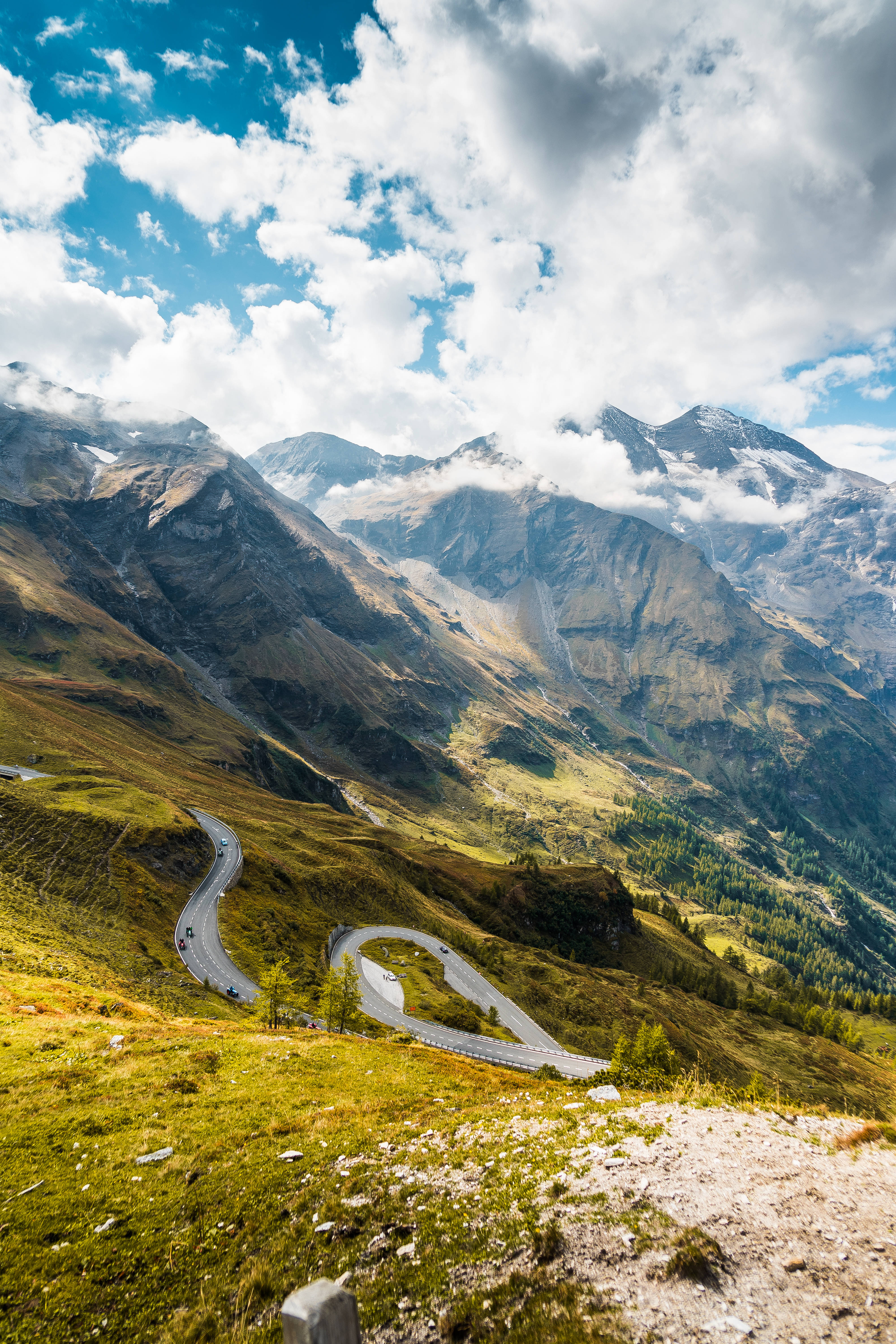 cloudy mountains, winding mountain road, lush green valleys, 5K Phone Wallpaper