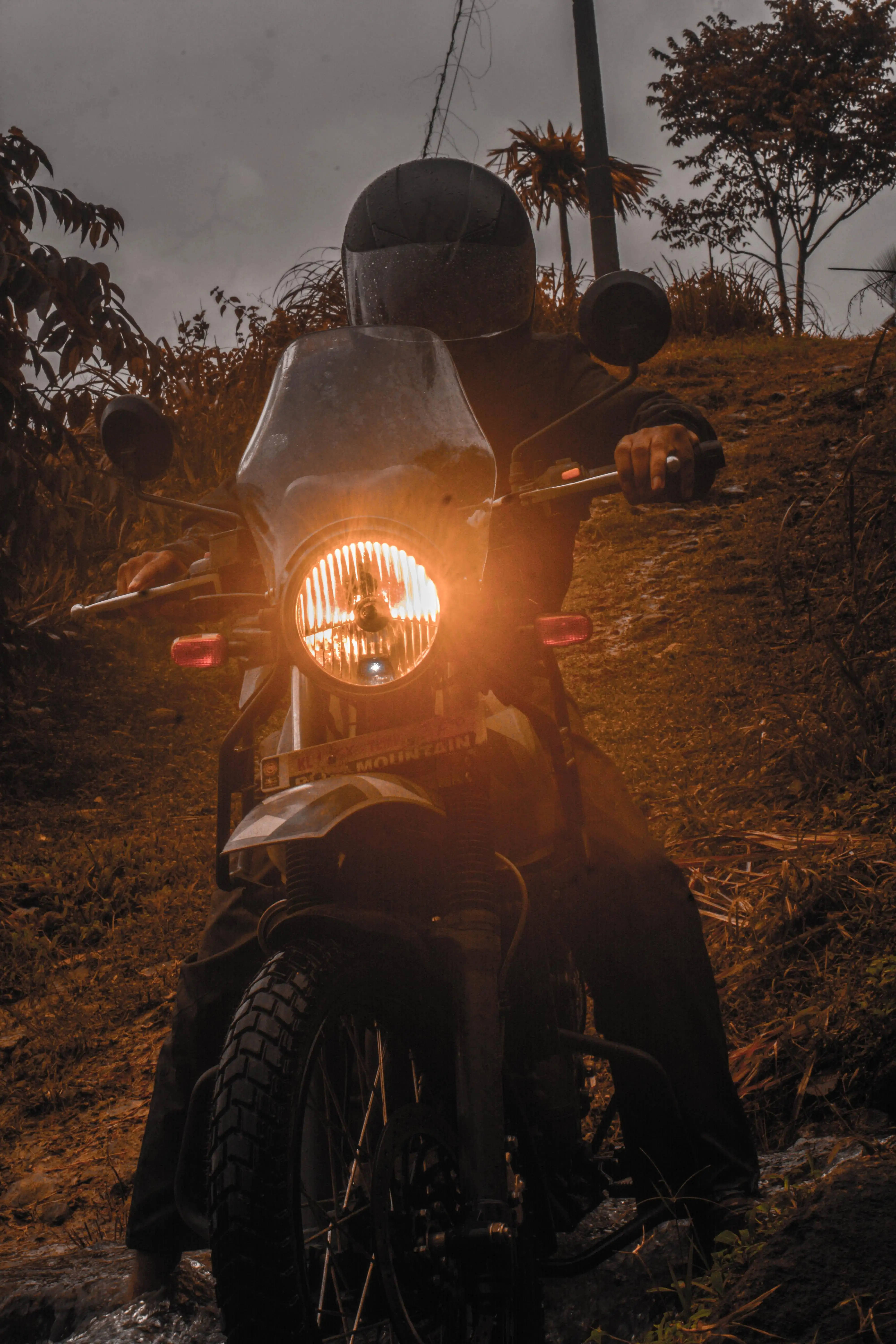 Himalayan, glowing headlight, muddy trail, 5K Phone Wallpaper