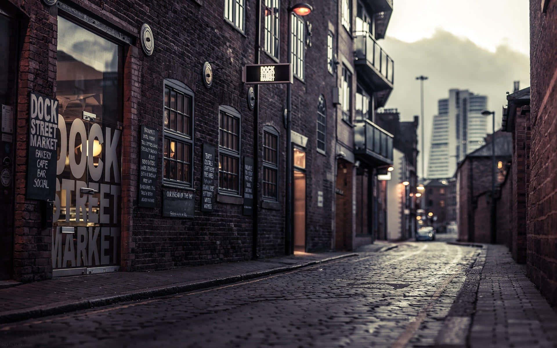 brick building, cobblestone alleyway, glowing shop windows, Full HD Desktop Wallpaper