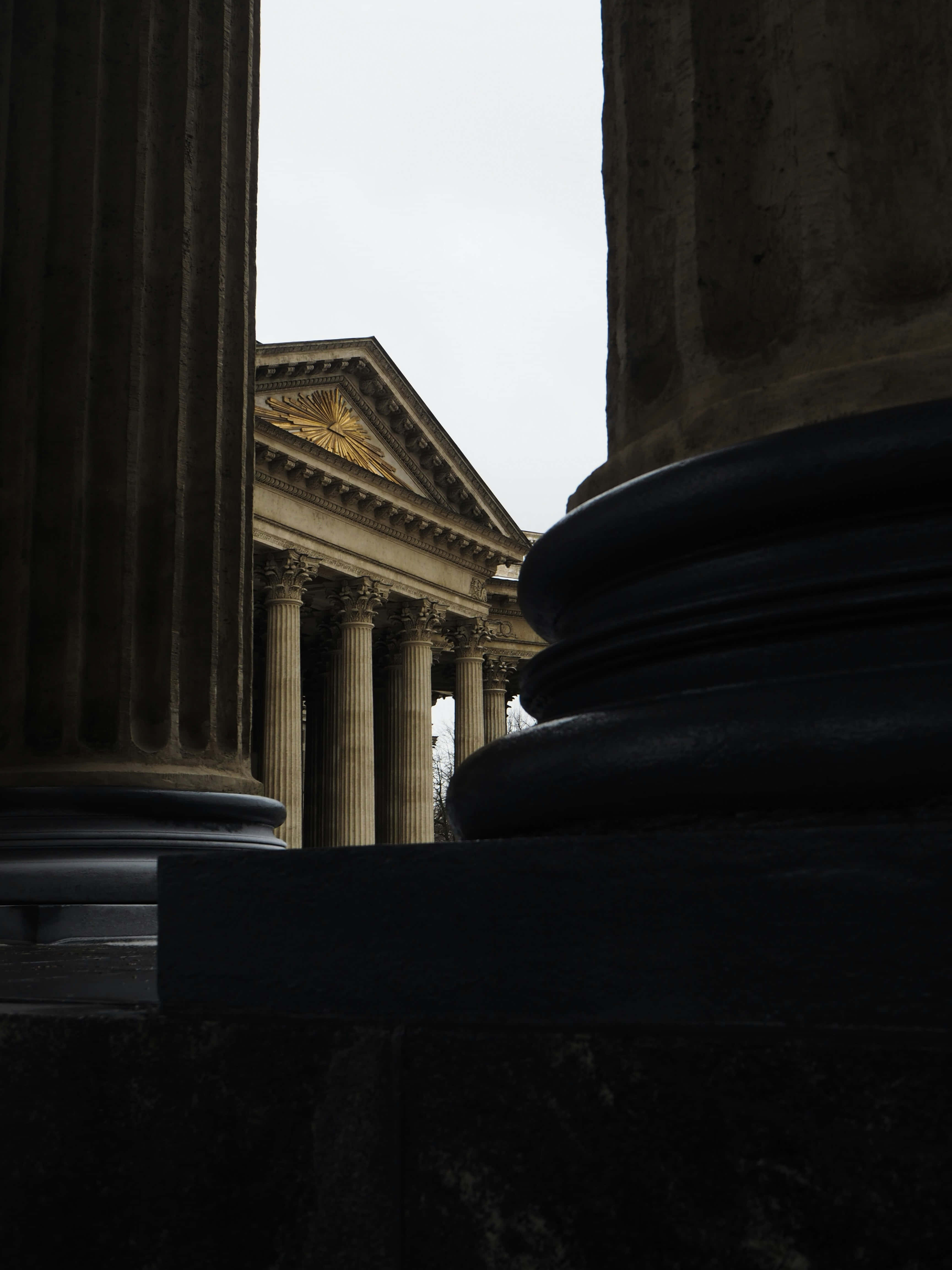 classical temple, golden sunburst pediment, dark stone columns, 4K Phone Wallpaper