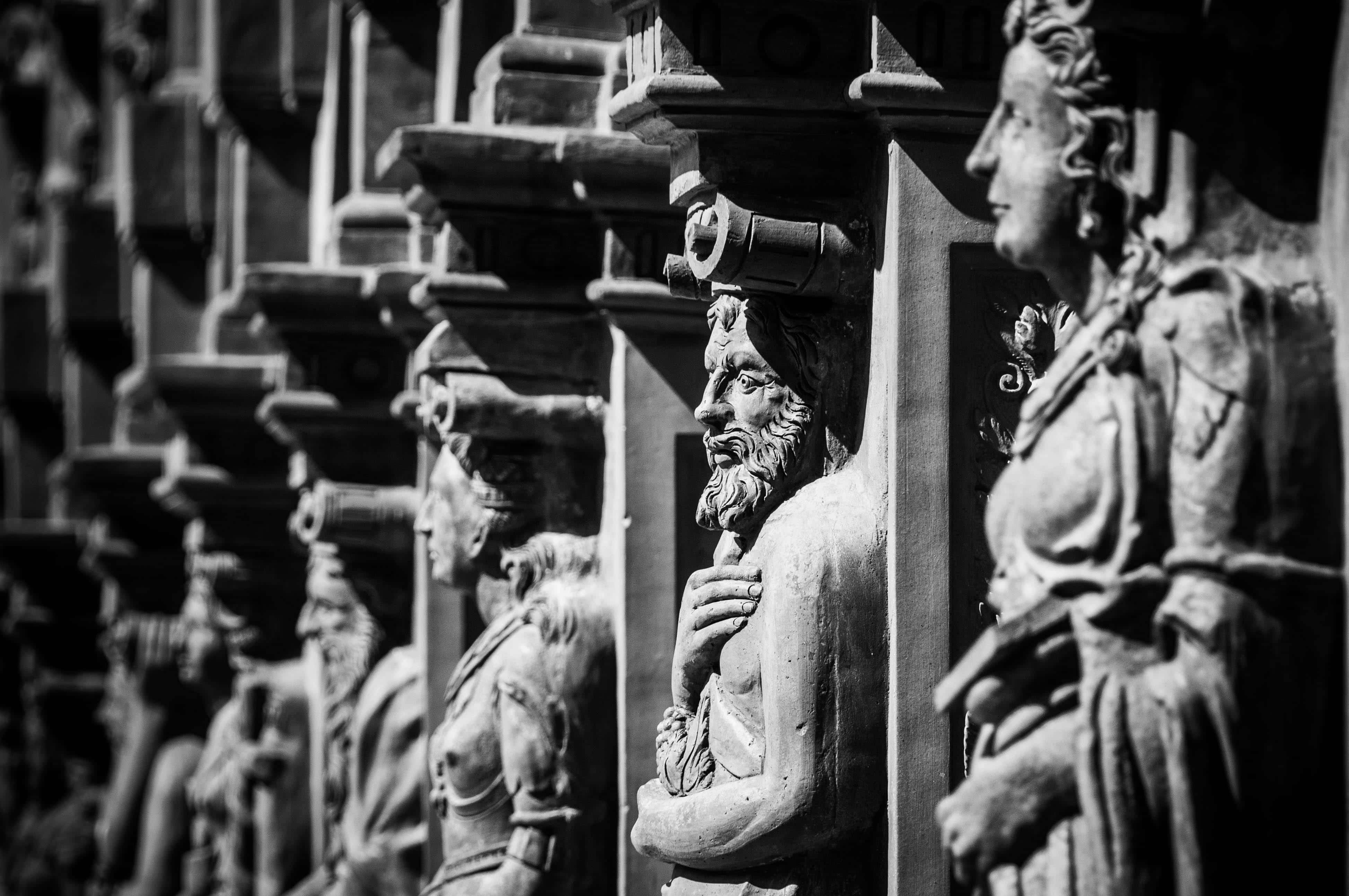 historical figures statues row, weathered stone statues, detailed facial expressions, 4K Desktop Wallpaper