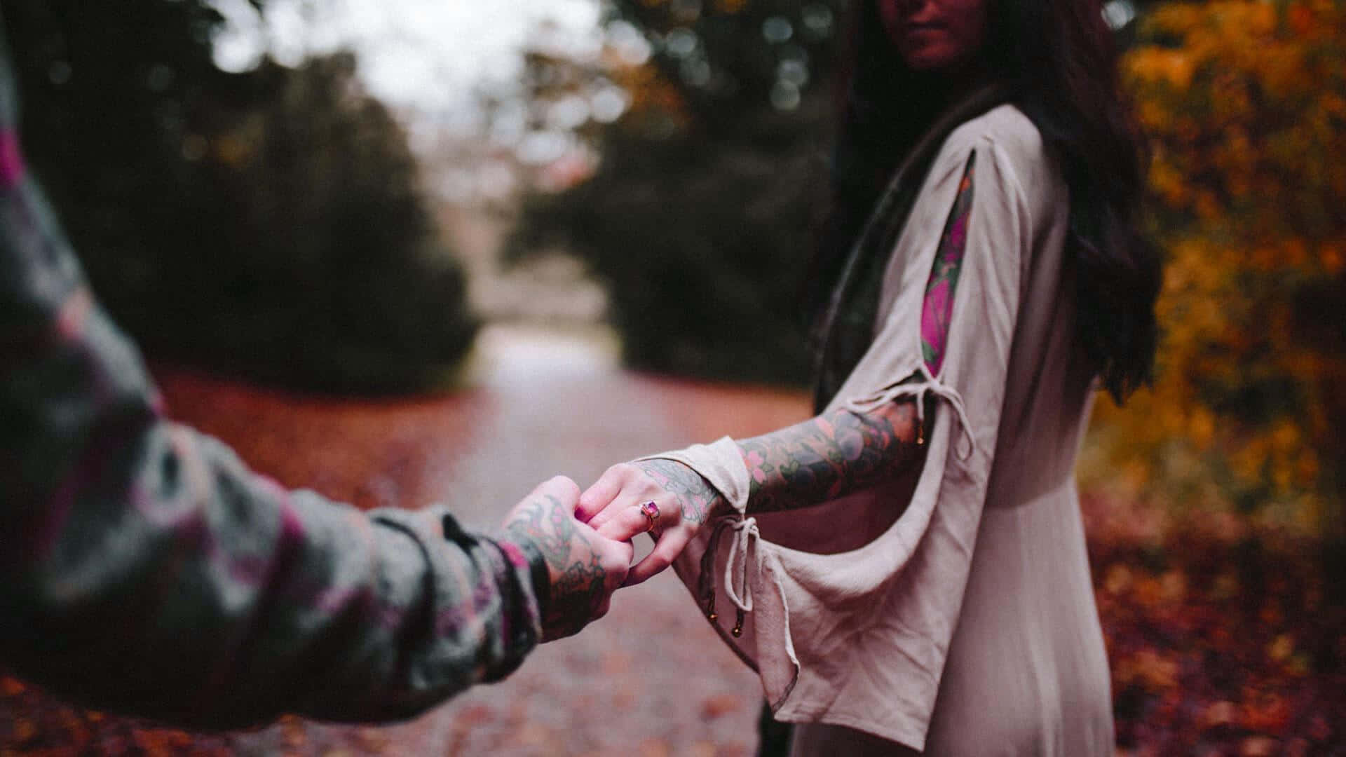 tattooed hands, leaf-strewn autumn path, blurred trees, Full HD Desktop Wallpaper