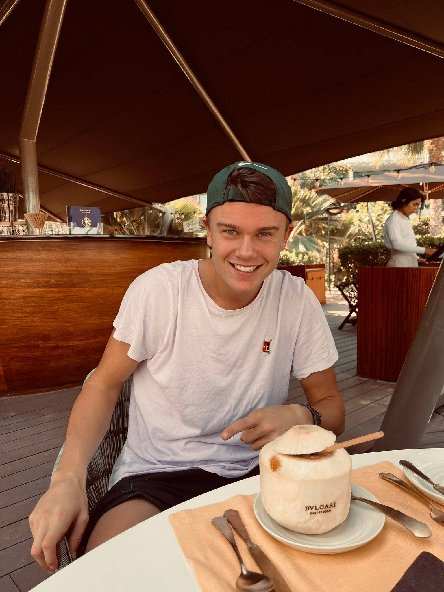 Holger Rune, green cap, wooden table, Full HD Phone Wallpaper